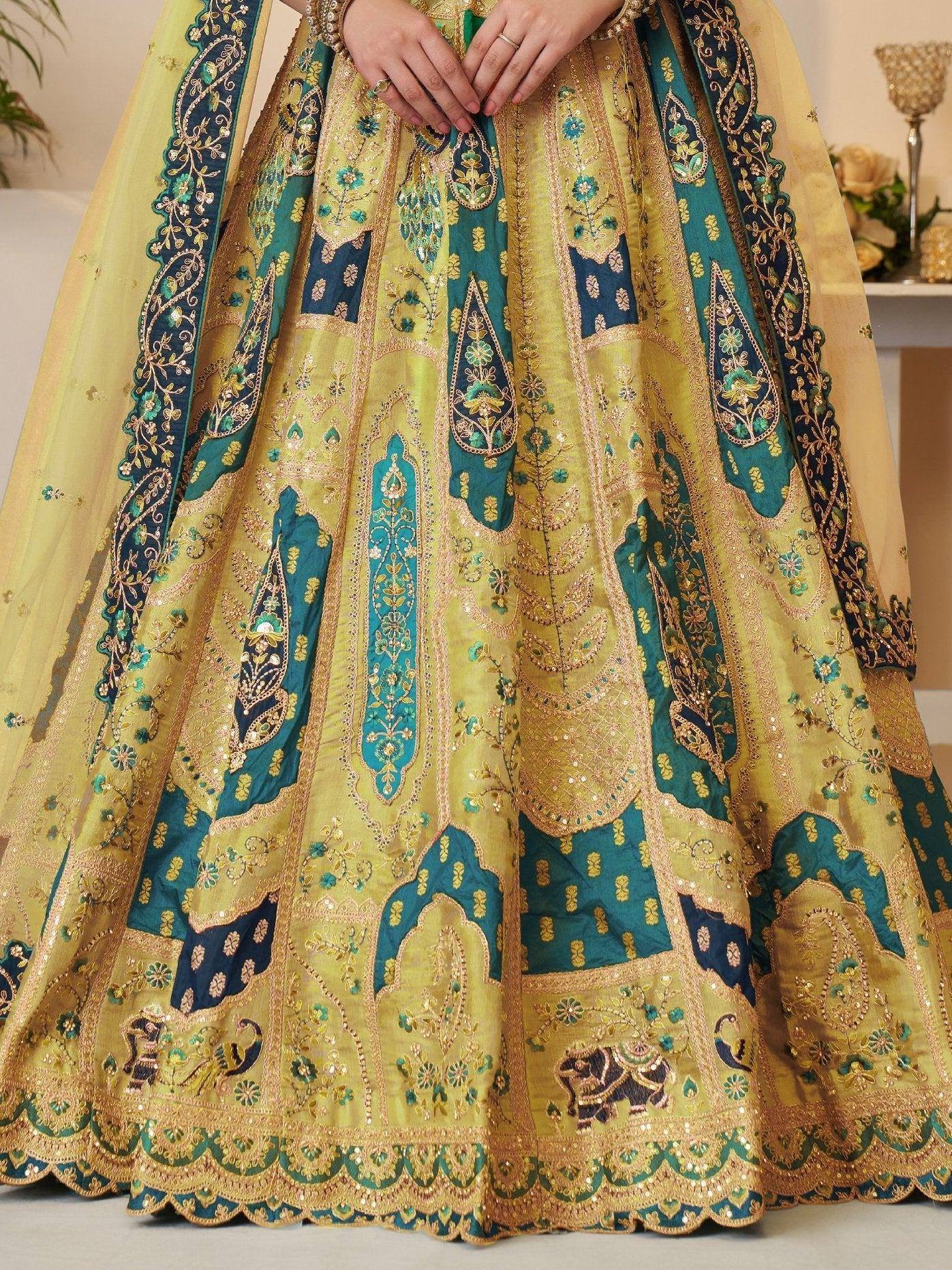 Yellow and teal embroidered lehenga choli with gold detailing and elephant motifs, perfect for Indian weddings