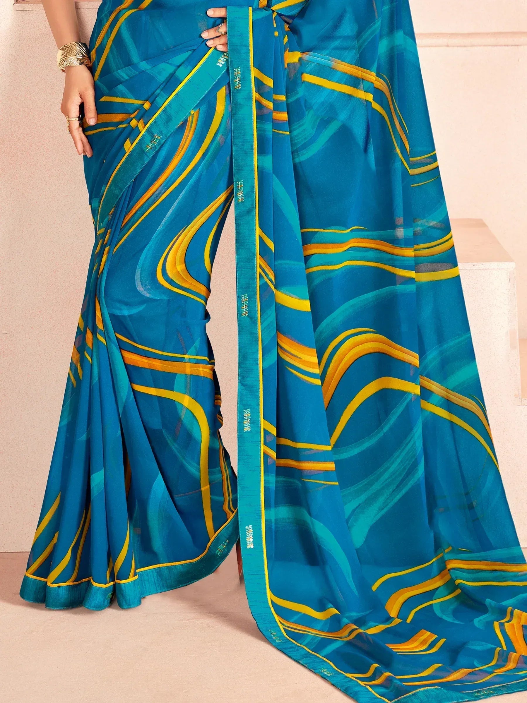 Blue and yellow abstract print saree with stylish drape, perfect for ethnic occasions
