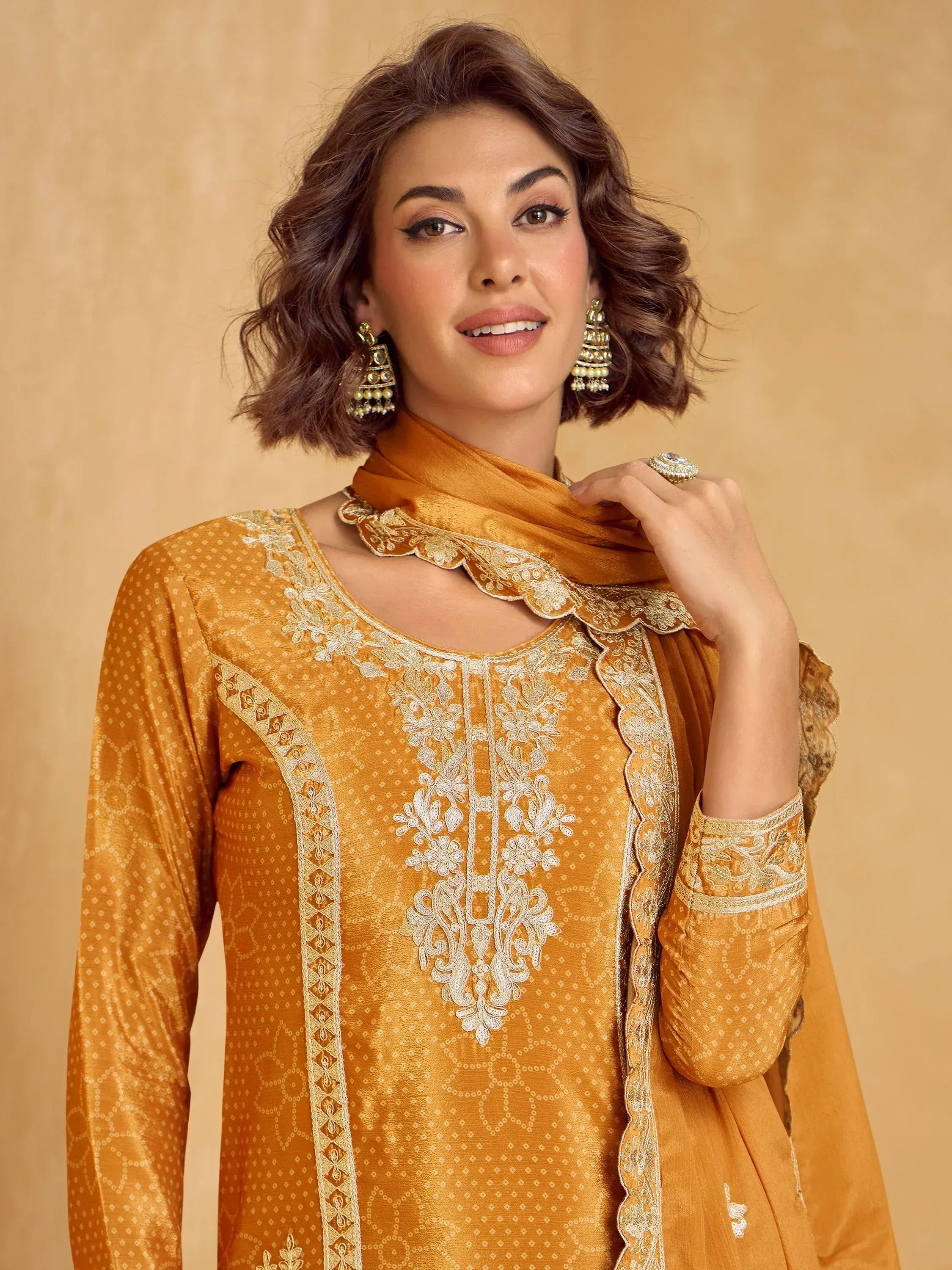 Mustard yellow embroidered salwar kameez with scalloped dupatta, perfect for ethnic occasions