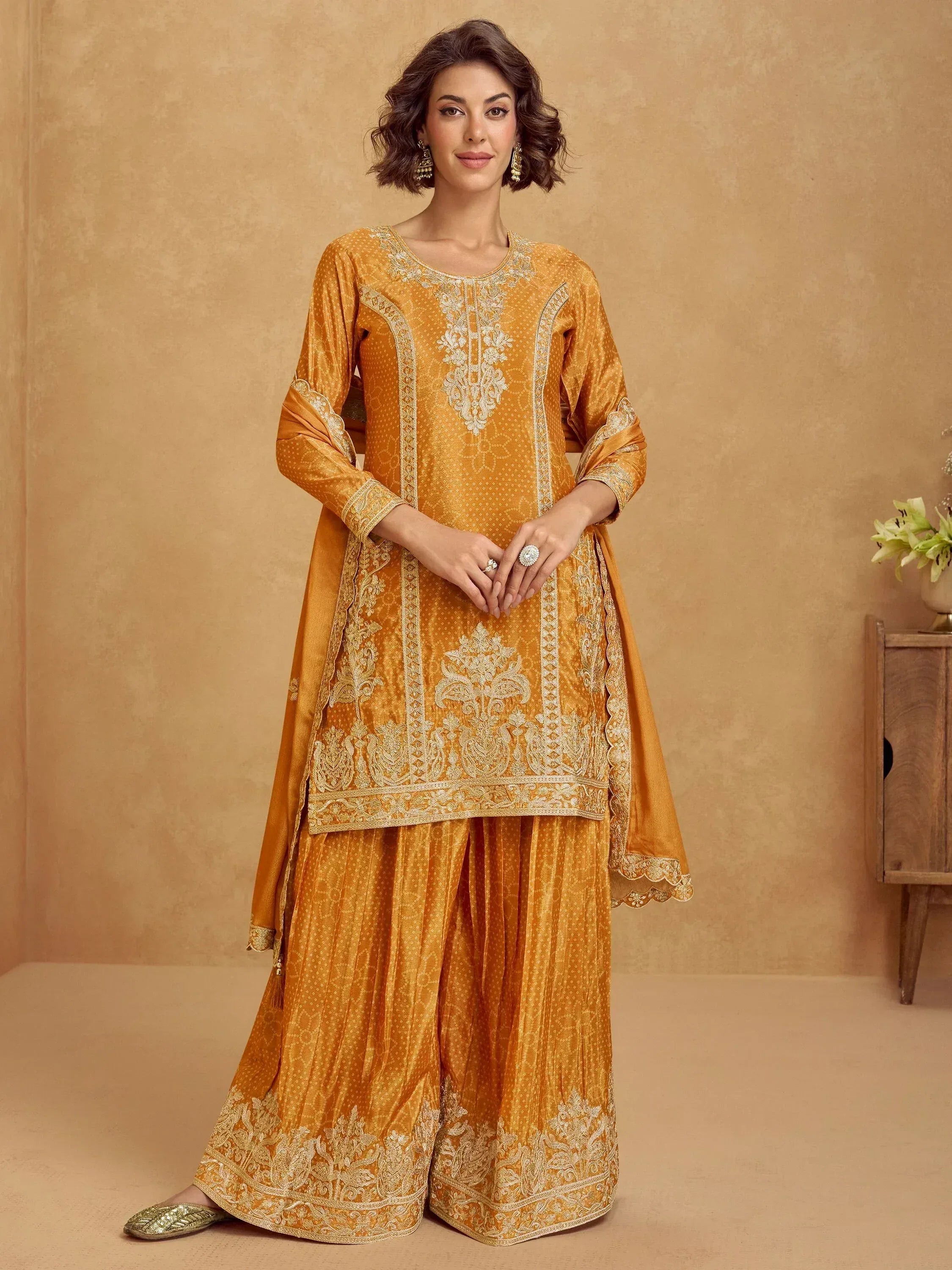 Golden embroidered salwar kameez with intricate floral detailing, perfect for ethnic occasions and festive wear.