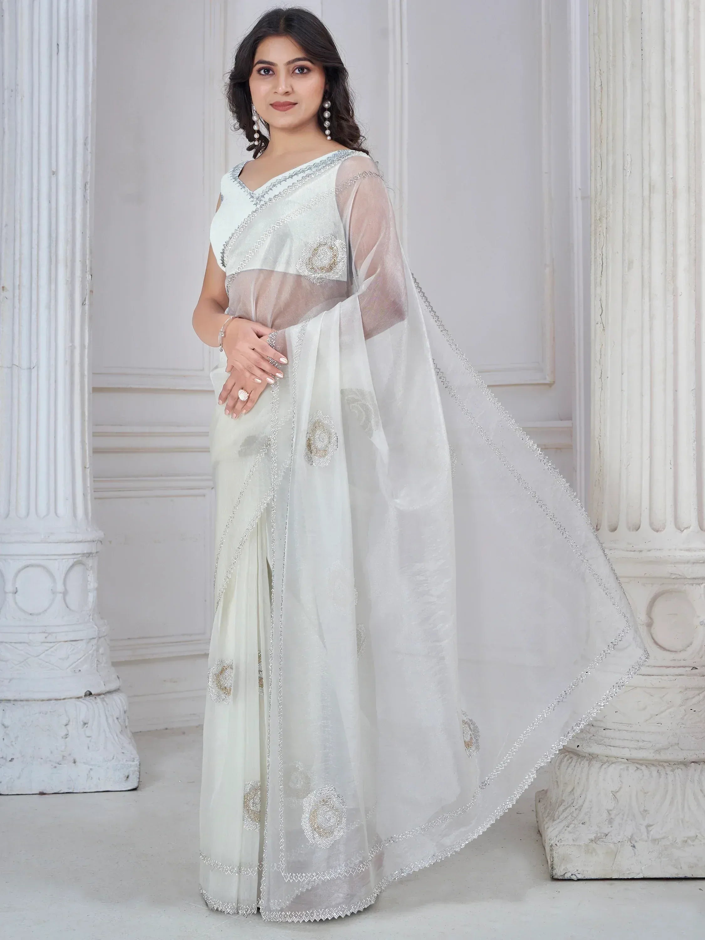 Elegant white saree with silver embroidery and floral motifs, perfect for Indian ethnic occasions.