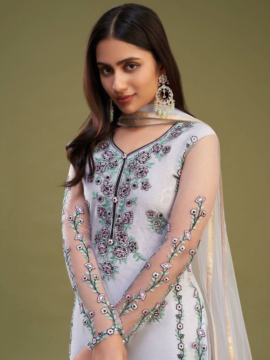 Woman wearing pastel floral embroidered salwar kameez with sheer sleeves and dupatta