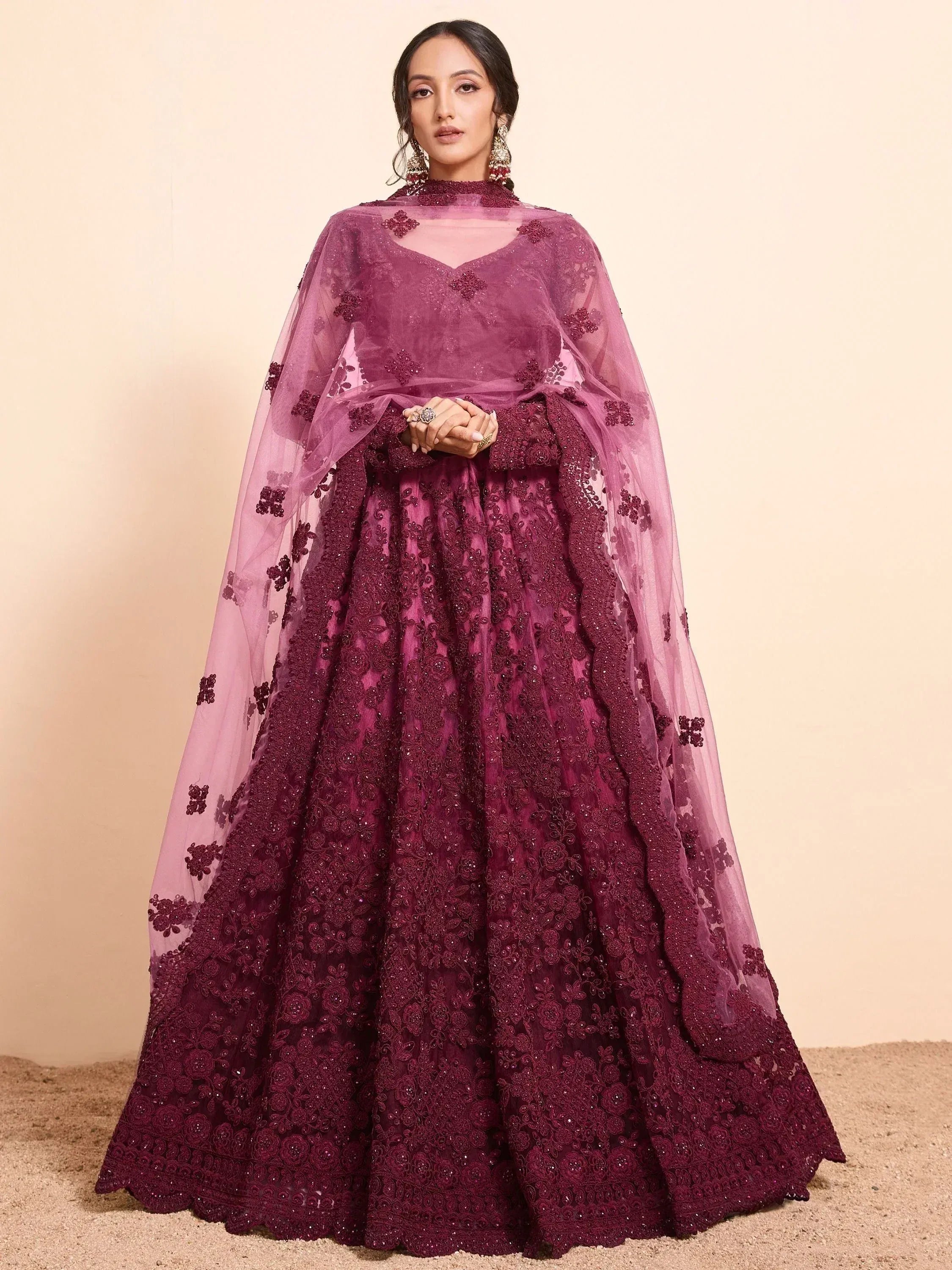 Burgundy embroidered lehenga choli with sheer cape, perfect for Indian weddings and festive occasions.