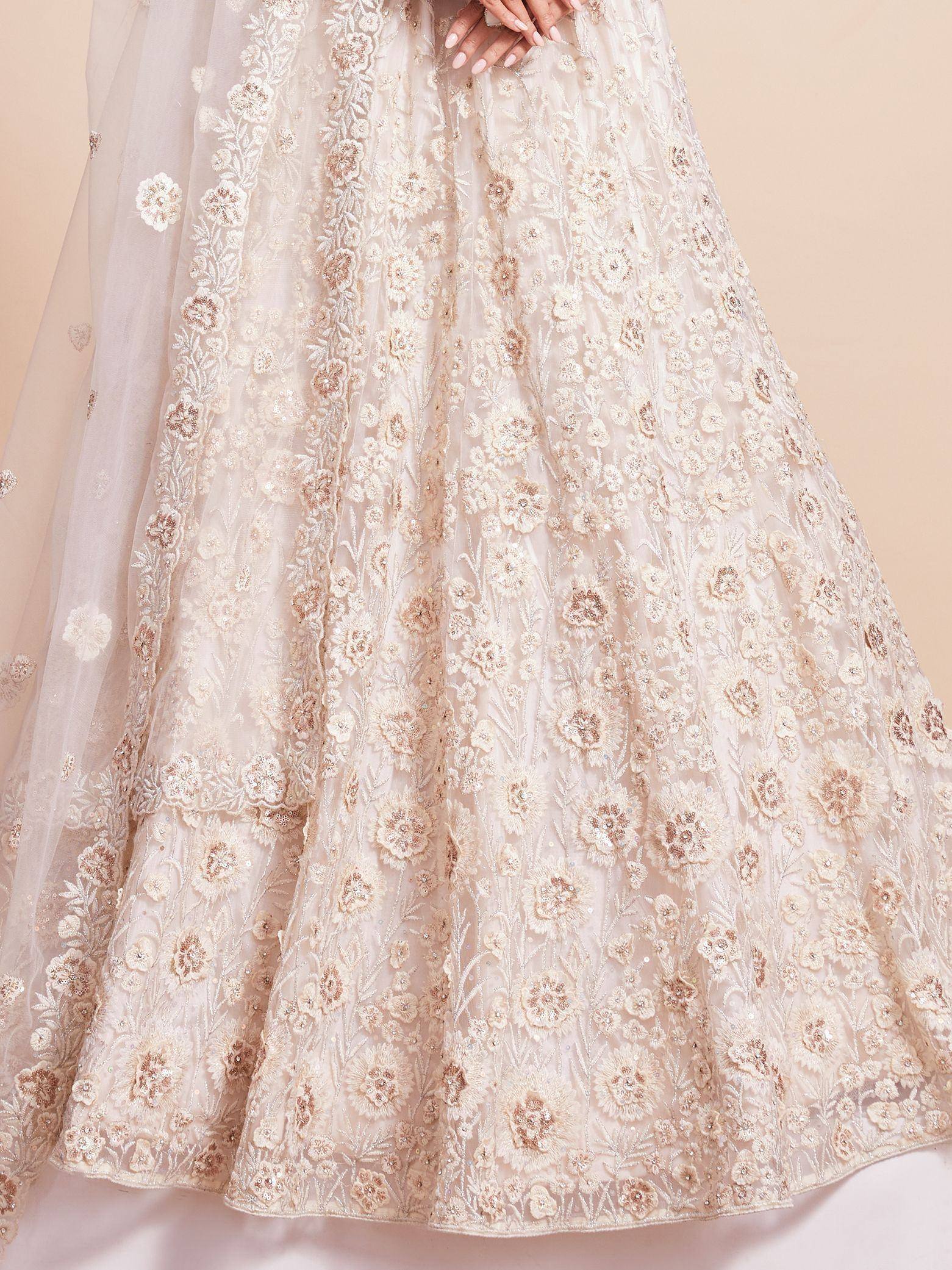 Elegant ivory lehenga with floral embroidery and sequin detailing for Indian ethnic wear