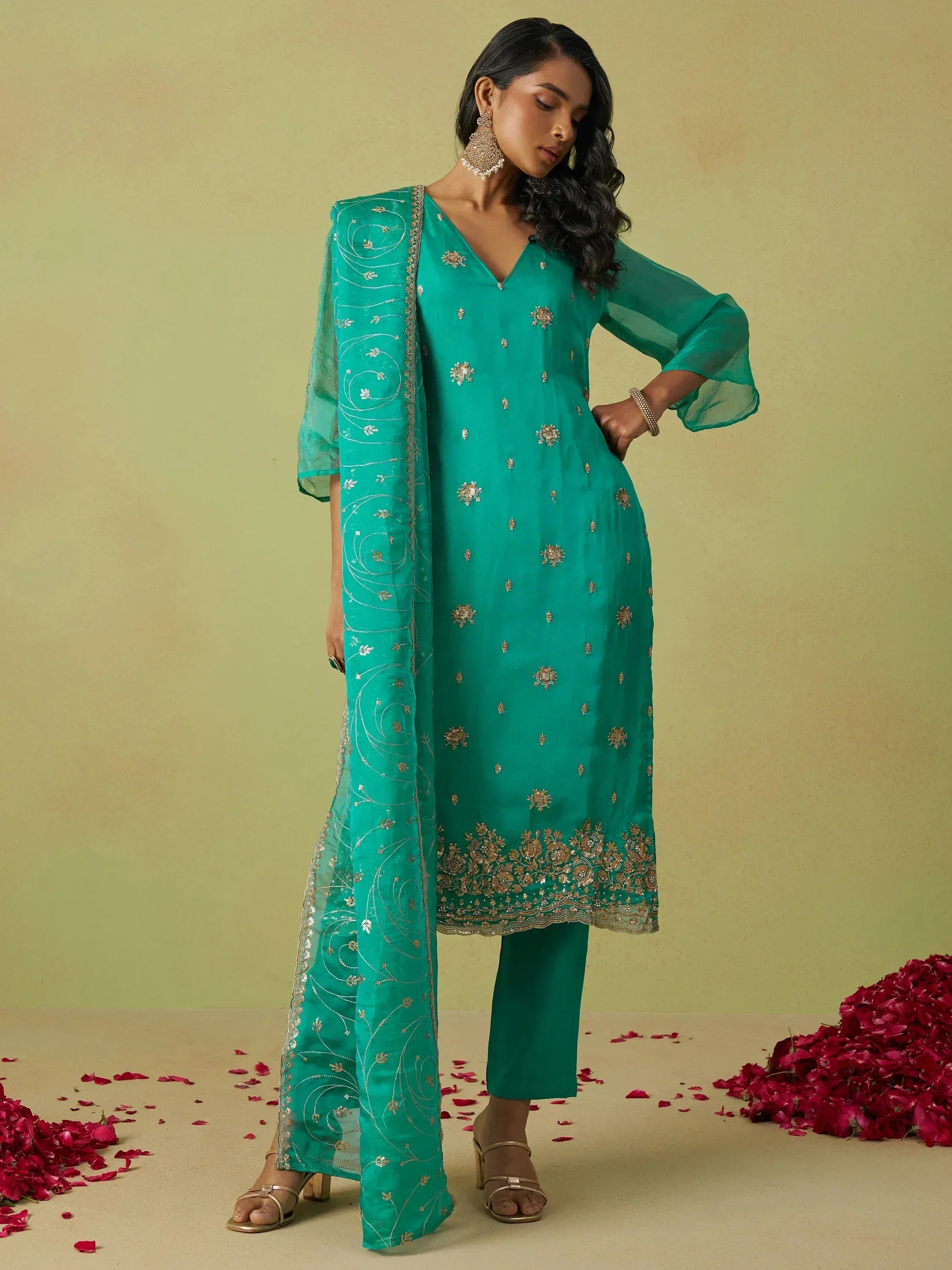 Emerald green embroidered salwar kameez with sheer dupatta, perfect for ethnic wear occasions.