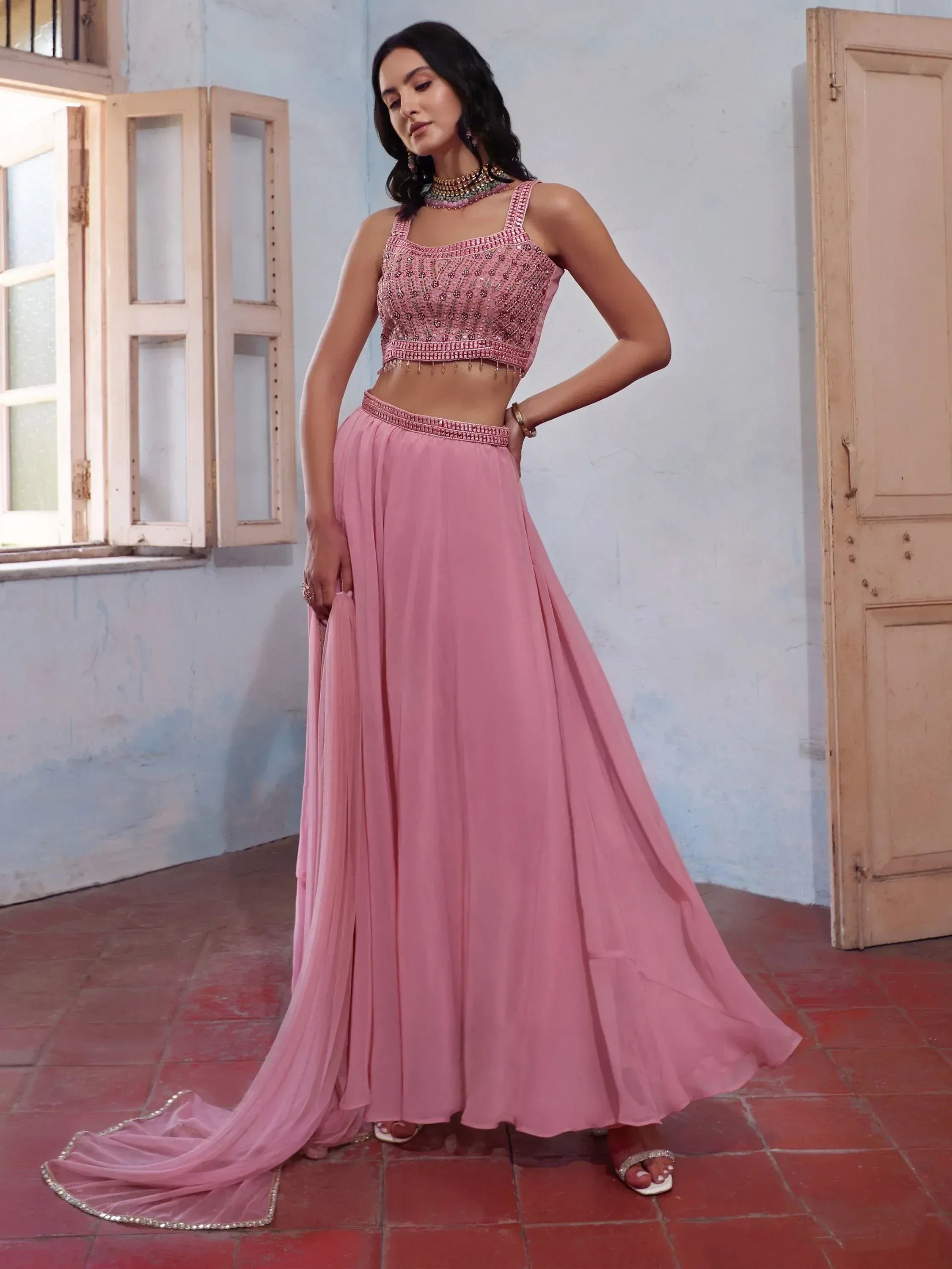 Pink embroidered lehenga choli with flared skirt and embellished crop top, ideal for Indian ethnic occasions