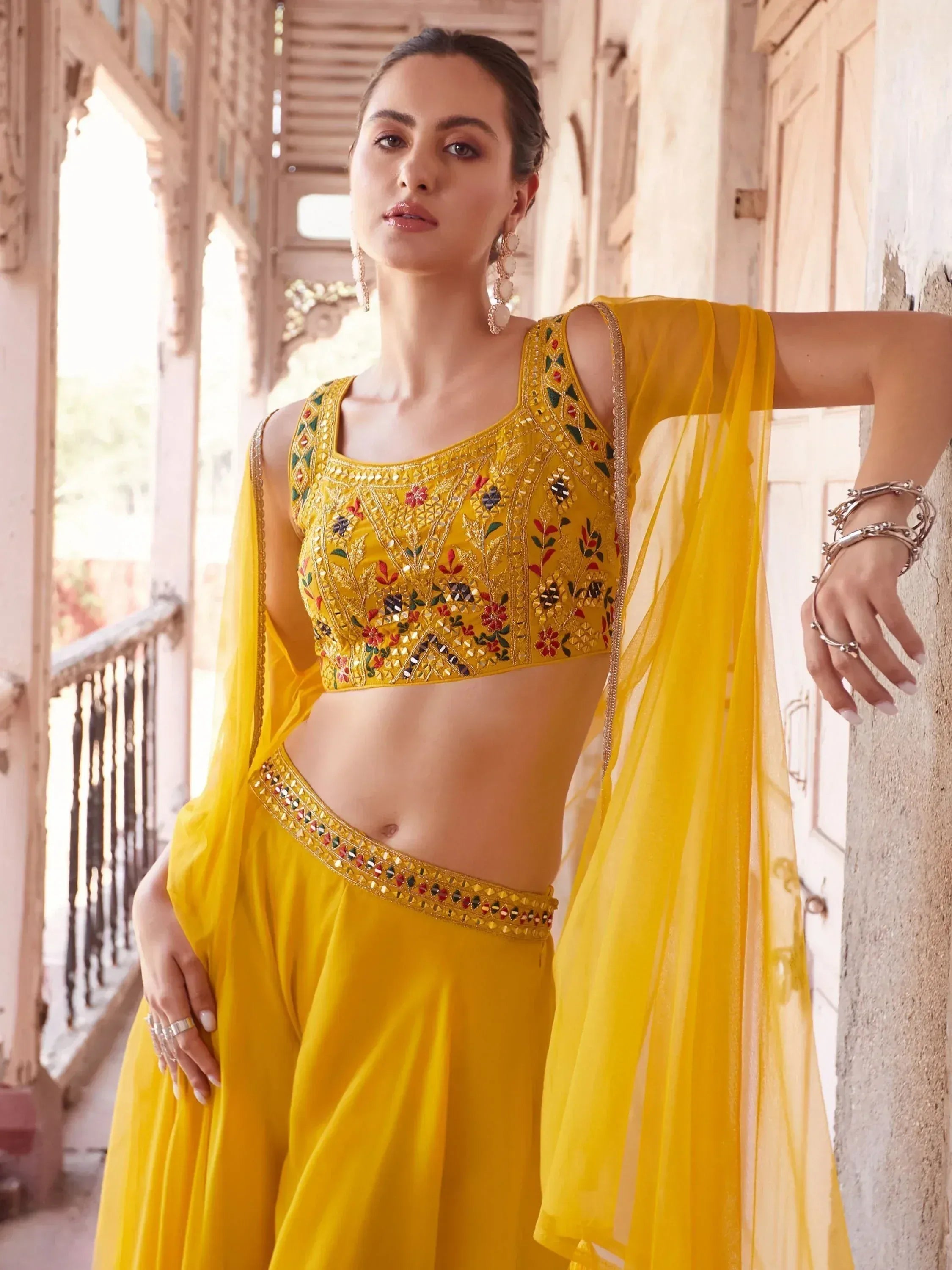 Woman in yellow embroidered lehenga choli with dupatta, Indian ethnic wear fashion