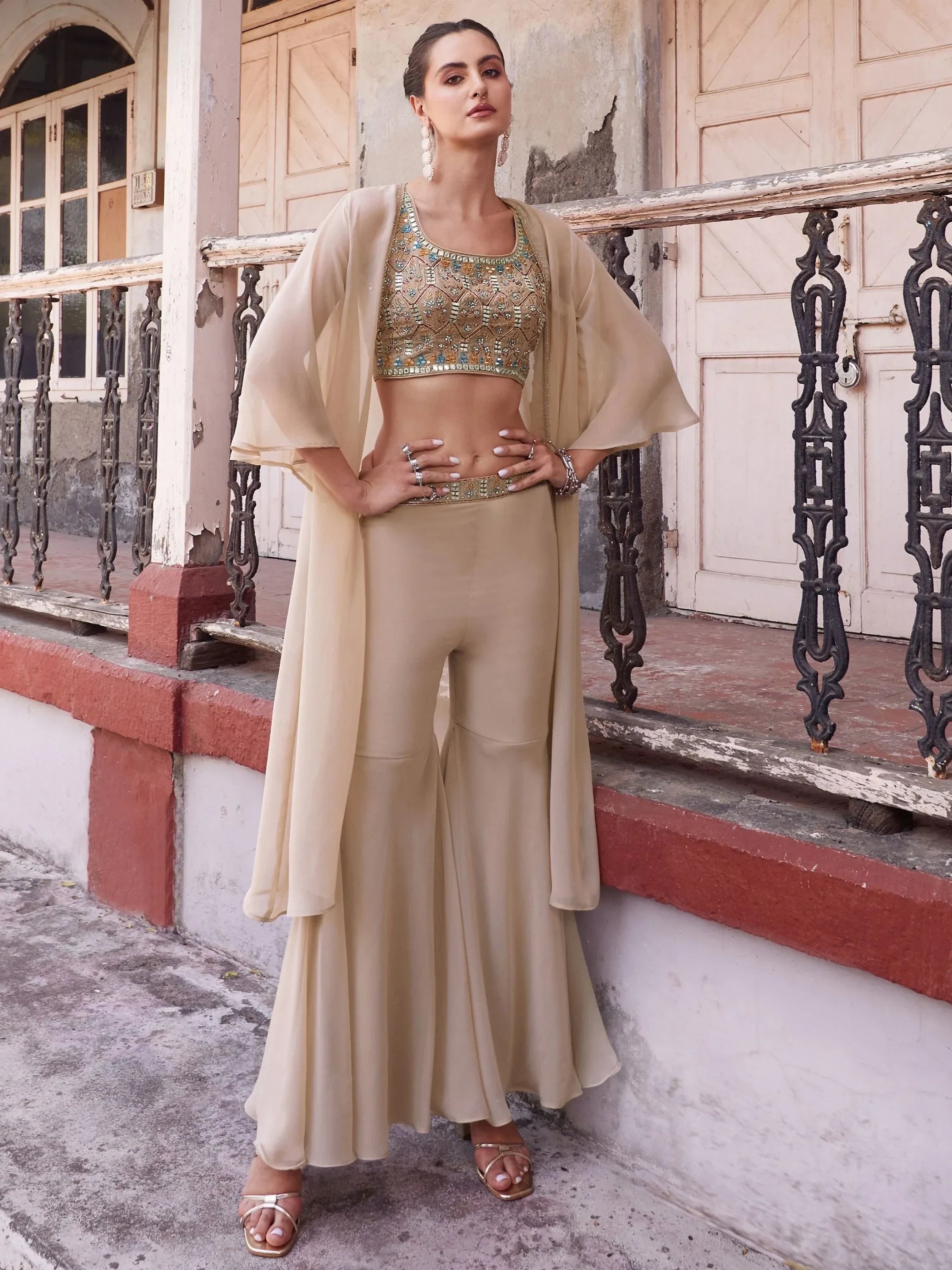 Woman in beige embroidered crop top and flared palazzo pants ethnic set, outdoor setting