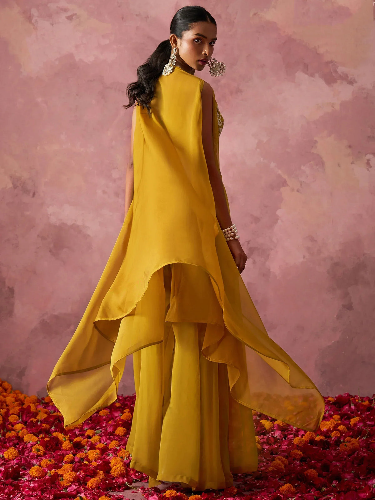 Mustard yellow ethnic gown with high-low hem, paired with palazzo pants, perfect for Indian festive occasions.