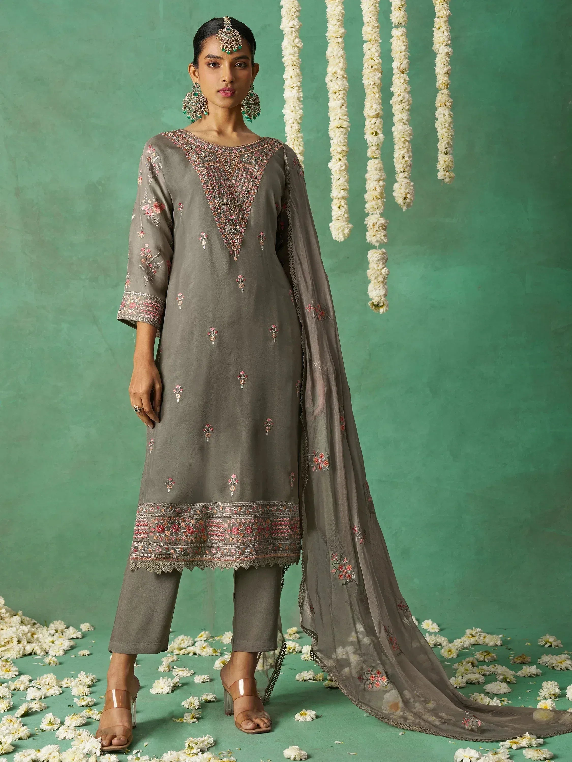 Grey embroidered salwar kameez with floral details, dupatta, and traditional jewelry for ethnic wear