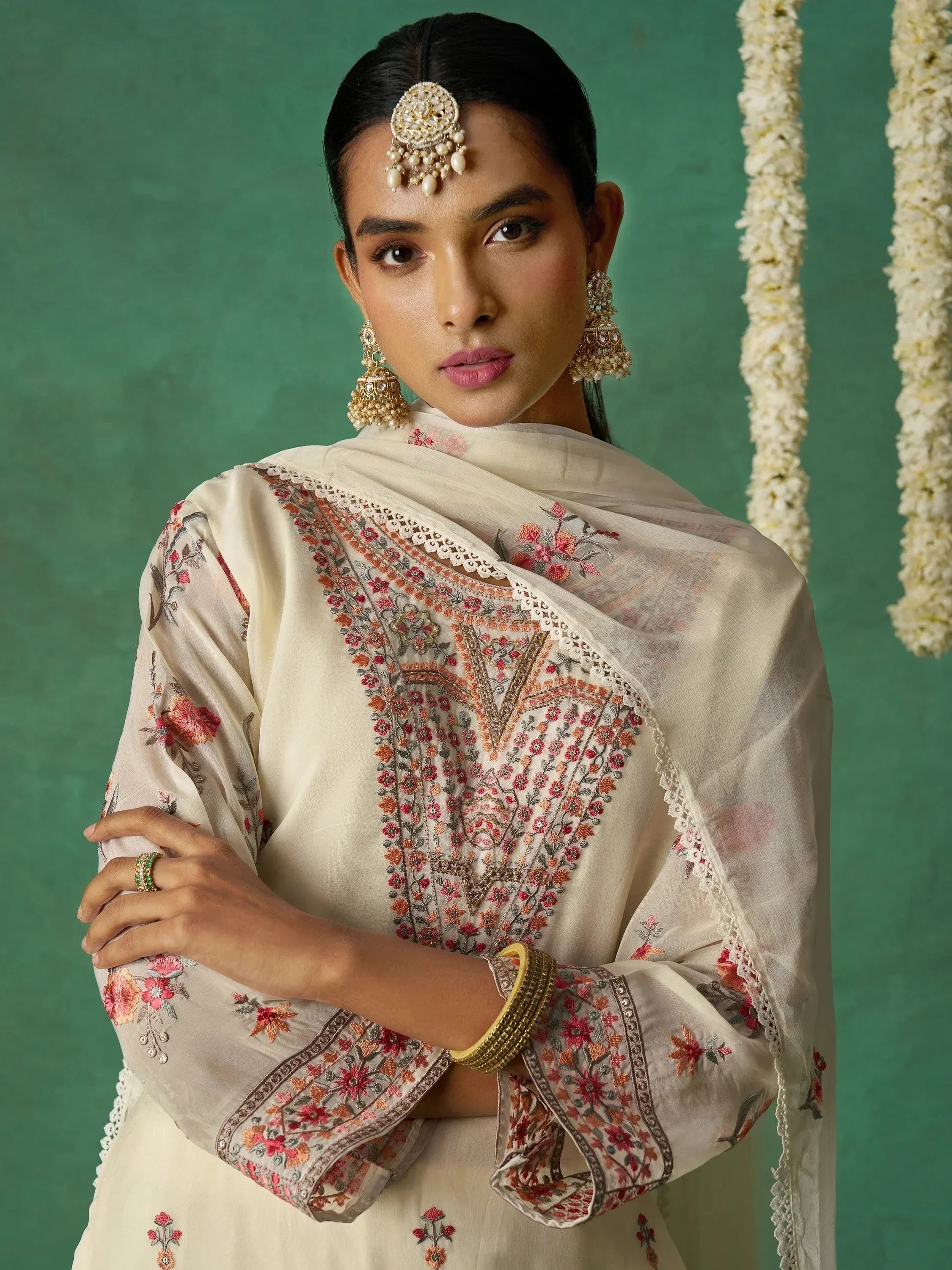 Elegant Indian ethnic wear with floral embroidery, traditional jewelry, and dupatta for festive occasions