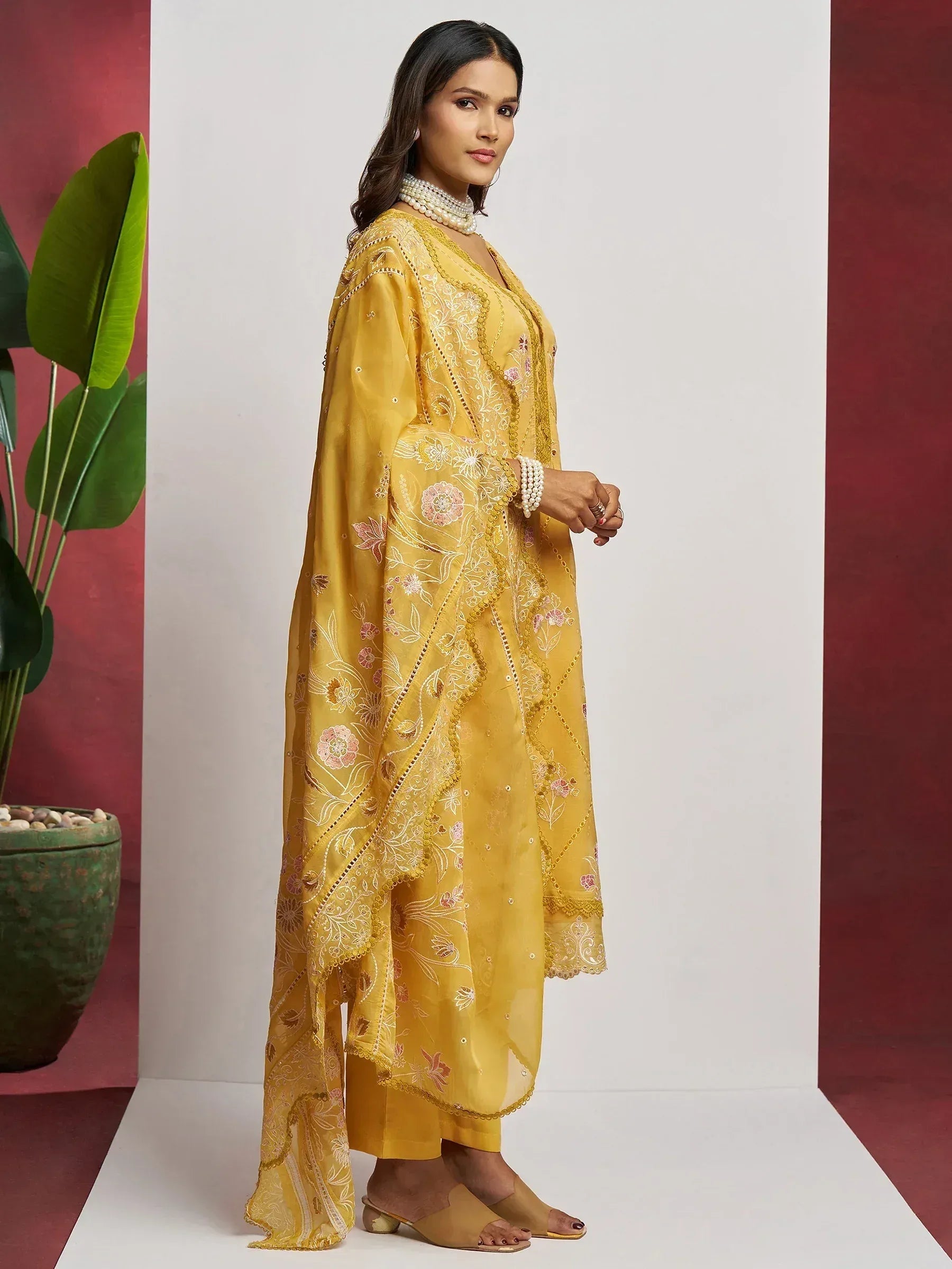Yellow embroidered salwar kameez with floral design, perfect for ethnic wear and festive occasions.