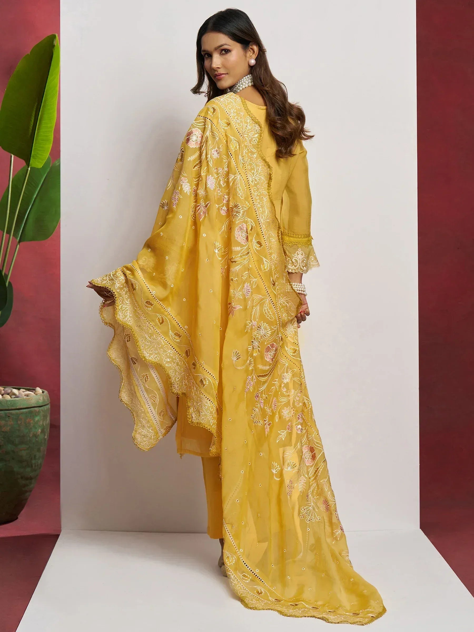 Yellow embroidered ethnic gown with floral detailing and flared sleeves
