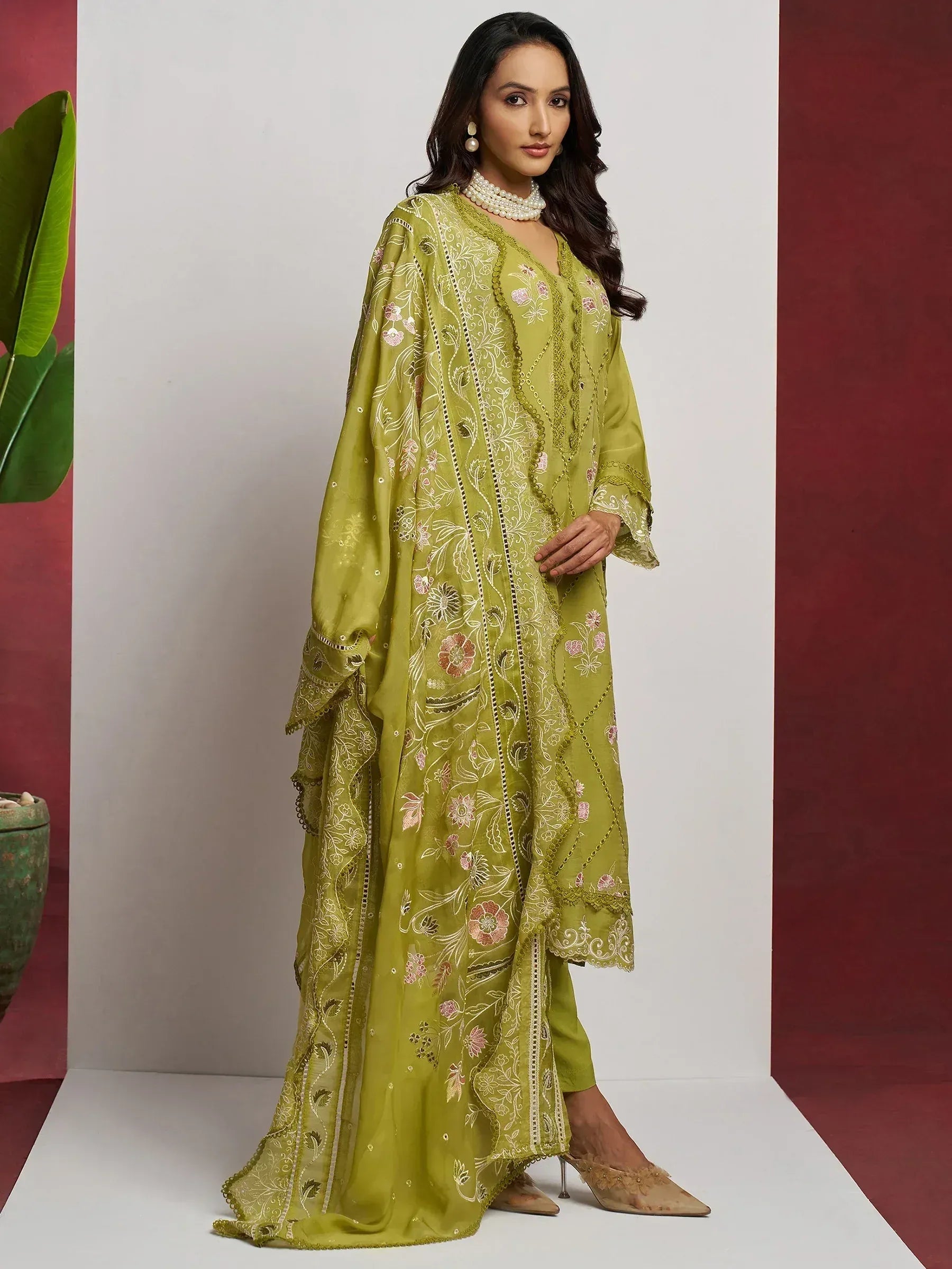 Olive green embroidered salwar kameez with floral motifs, perfect for Indian ethnic wear occasions.