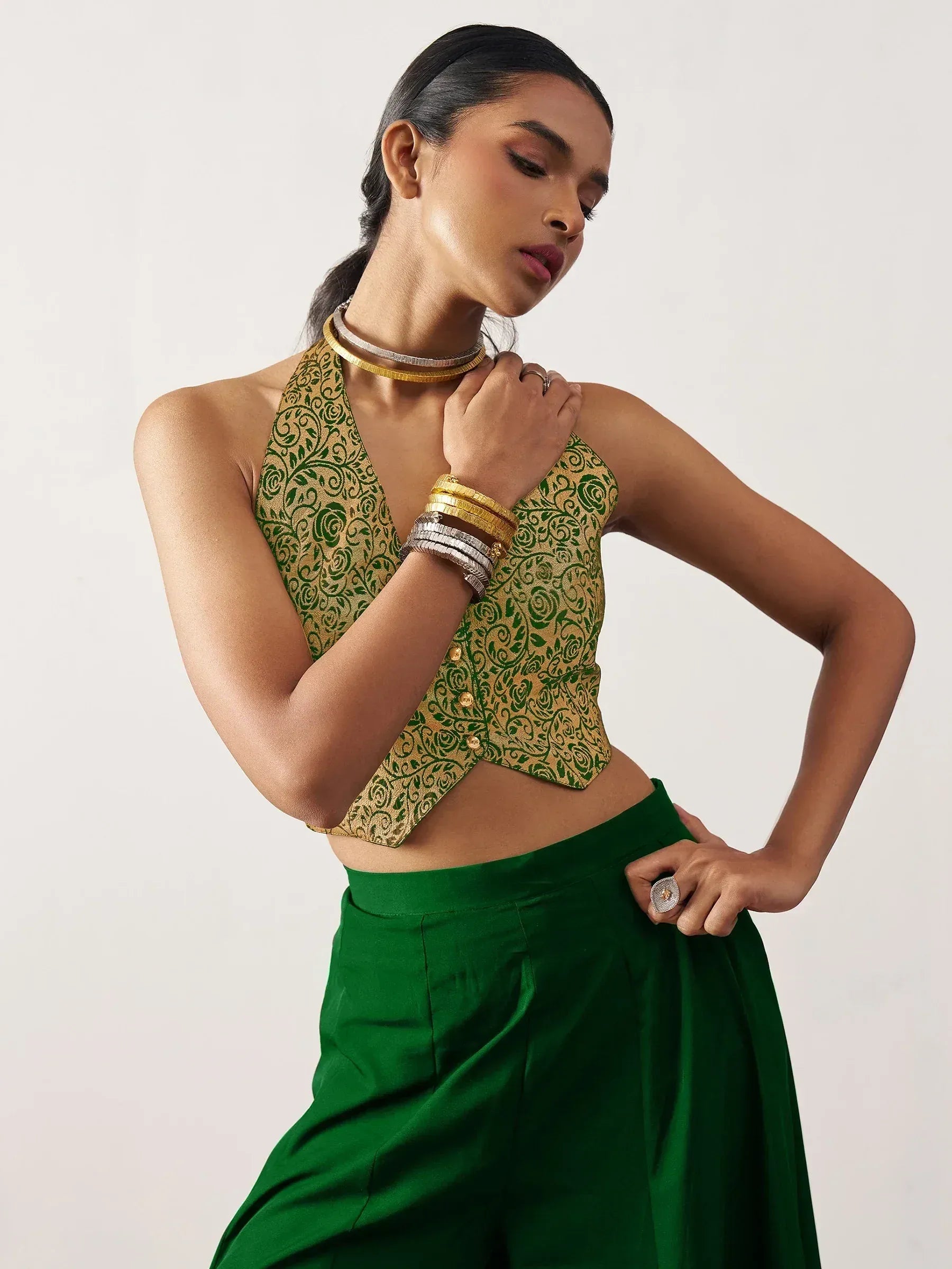 Green and gold floral halter top with matching palazzo pants, styled with statement jewelry for ethnic wear.