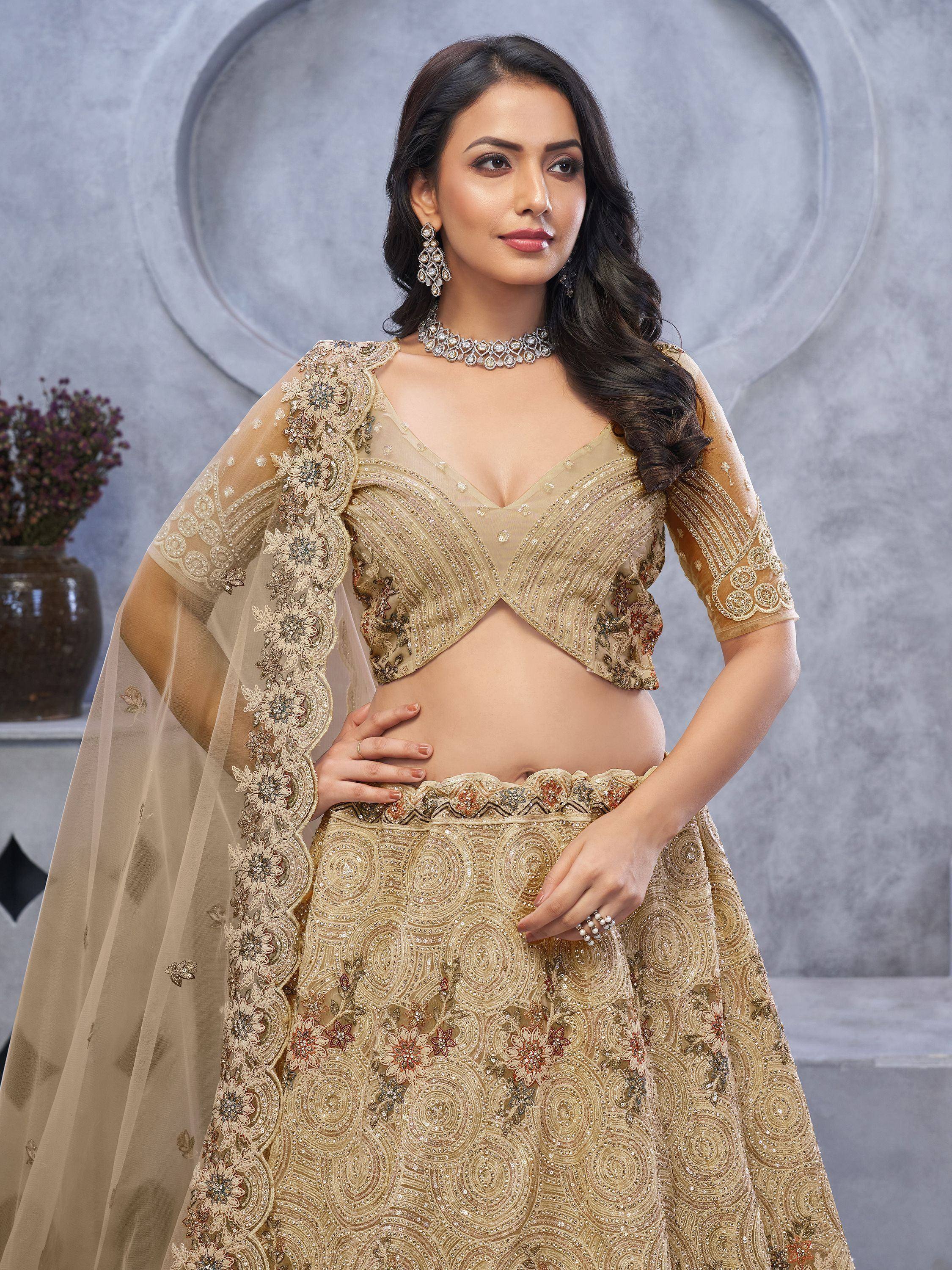 Elegant gold embroidered lehenga choli with floral detailing and sheer dupatta for Indian ethnic wear