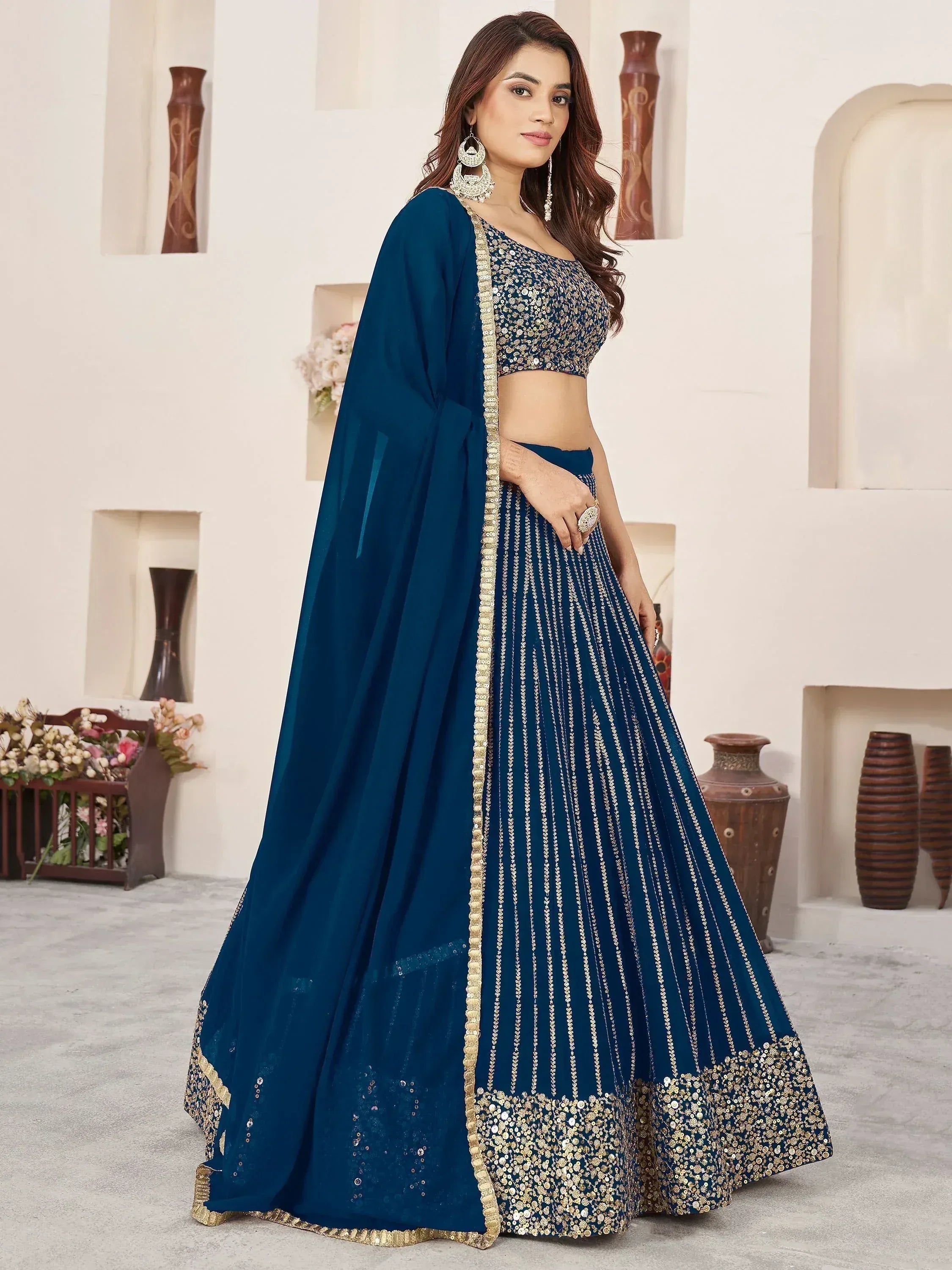 Blue designer lehenga choli with gold embroidery and sequins, perfect for Indian ethnic wear occasions