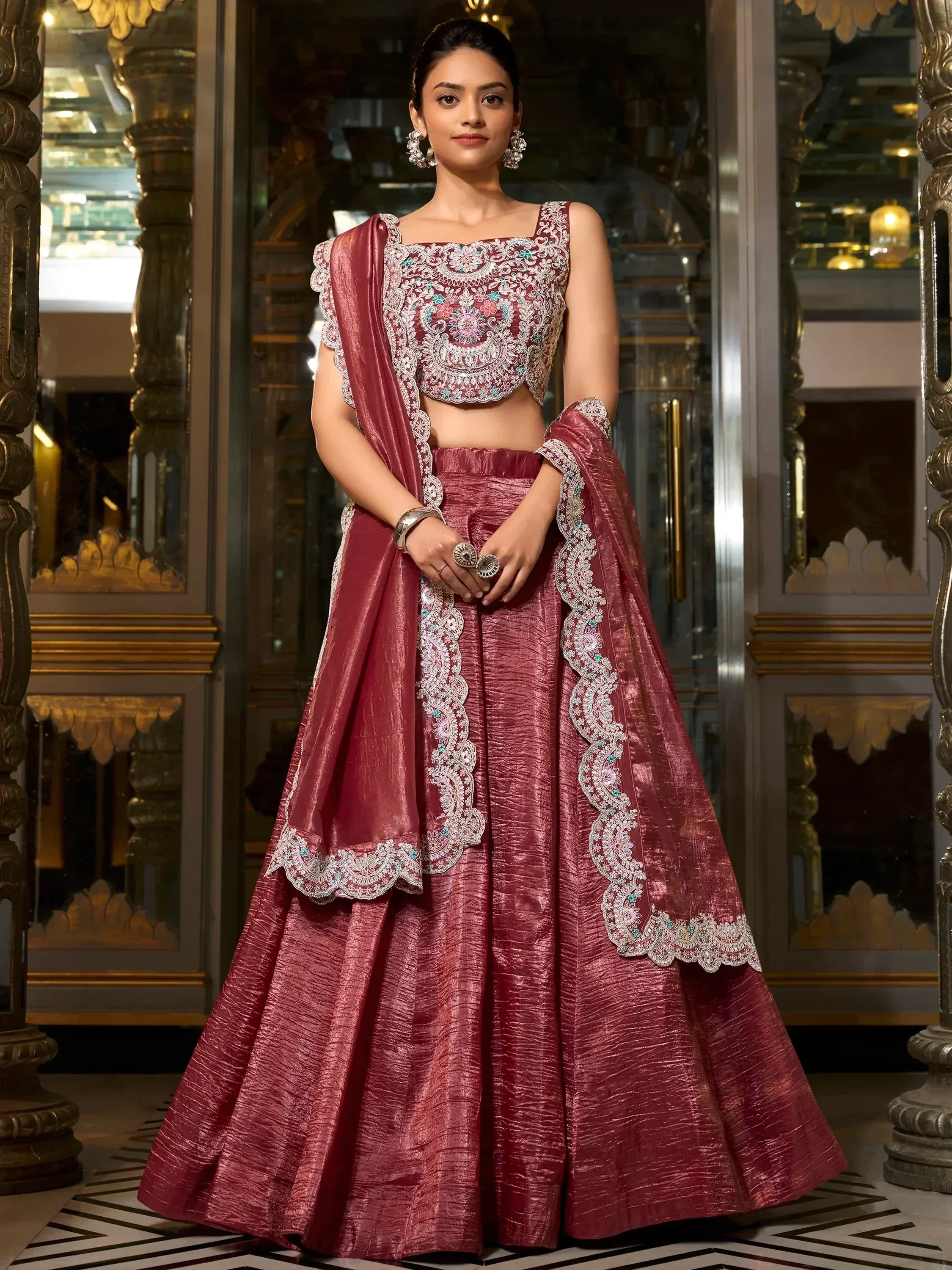 Elegant maroon lehenga choli with intricate embroidery, perfect for Indian weddings and festive occasions.