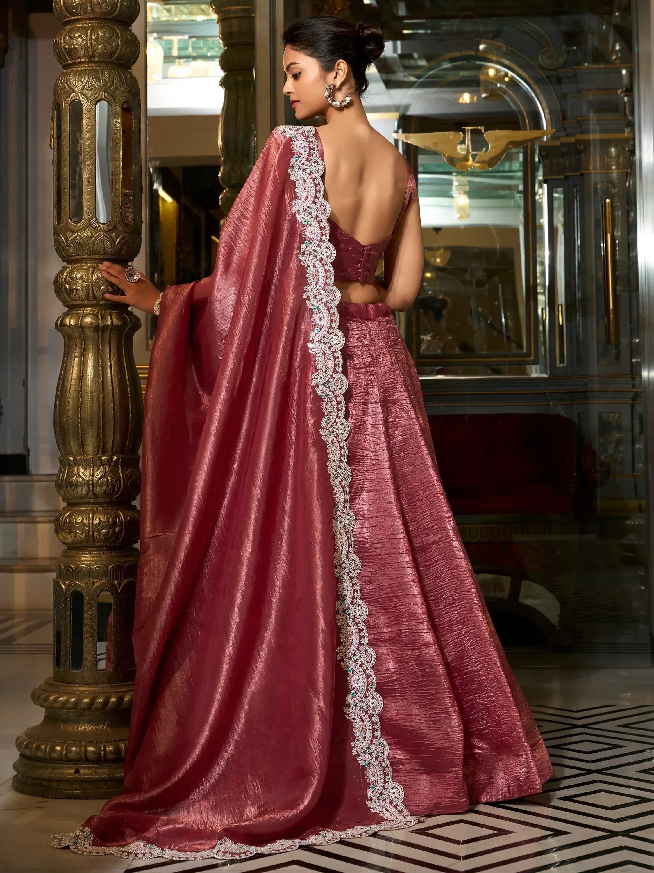 Elegant maroon lehenga choli with lace detailing, perfect for Indian weddings and festive occasions.