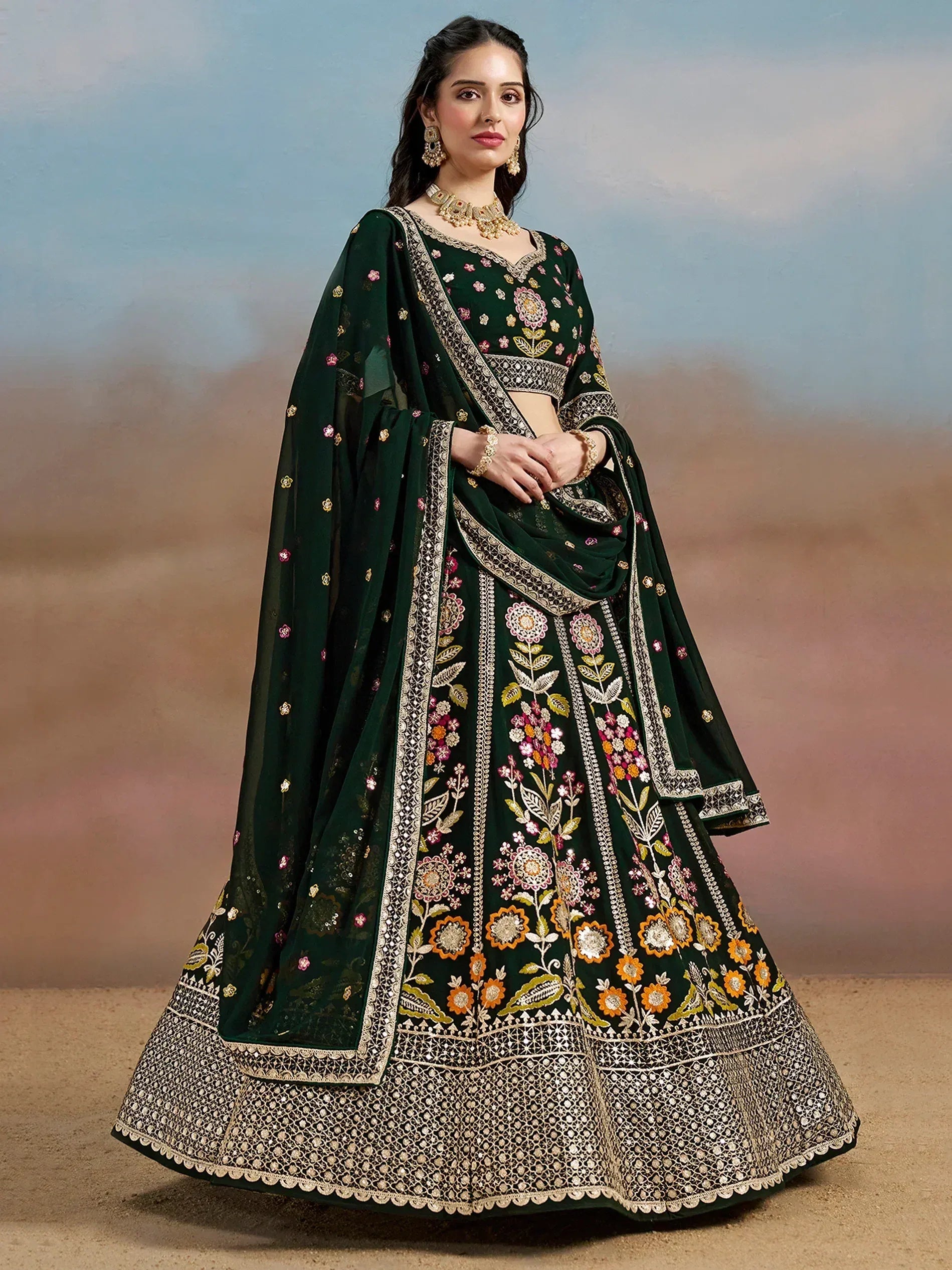 Emerald green embroidered lehenga choli with floral motifs and gold detailing, perfect for Indian ethnic wear.