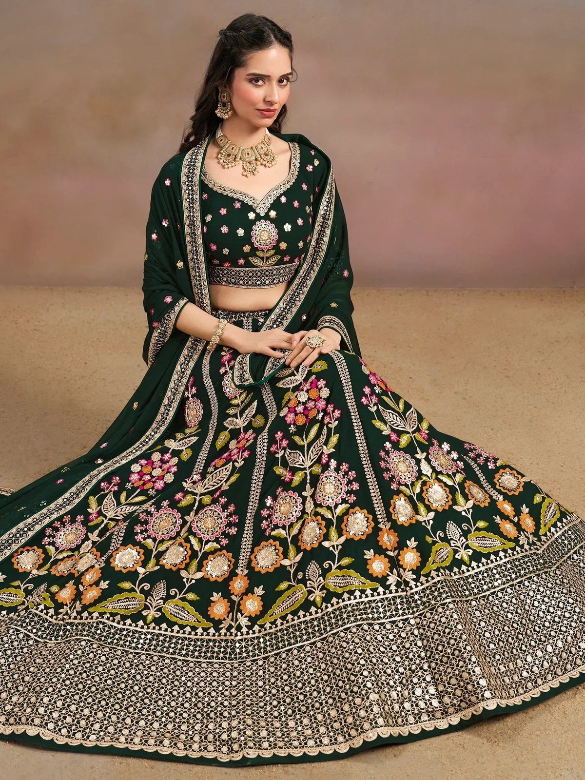 Emerald green designer lehenga choli with floral embroidery and gold detailing, perfect for Indian ethnic wear.