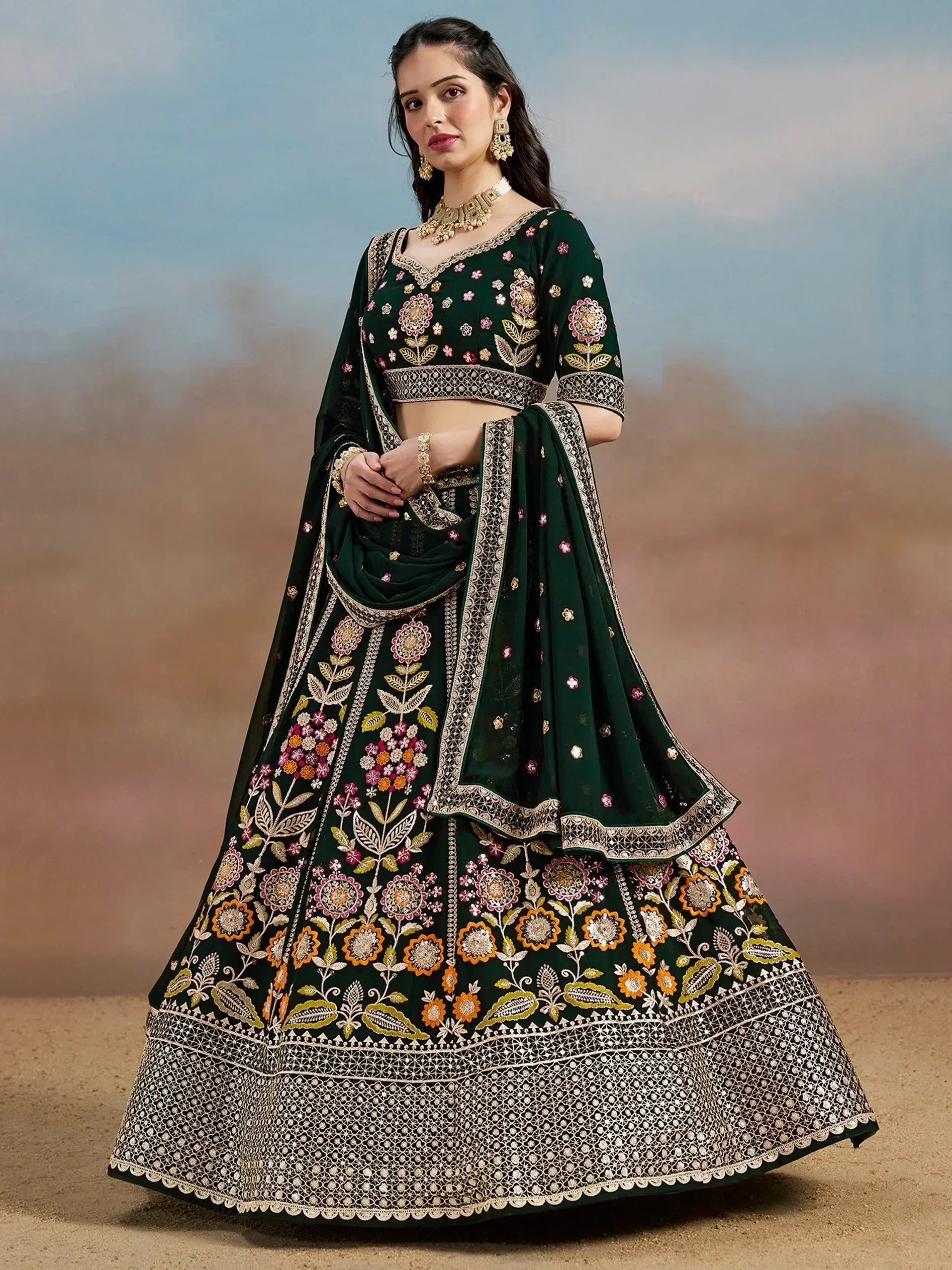 Emerald green embroidered lehenga choli with floral motifs and gold detailing, perfect for Indian weddings and festive occasions.