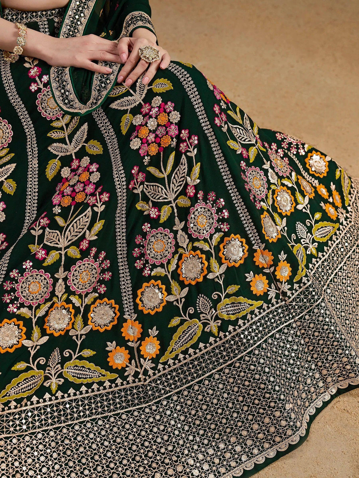 Emerald green ethnic gown with floral embroidery and sequin detailing, perfect for Indian occasions