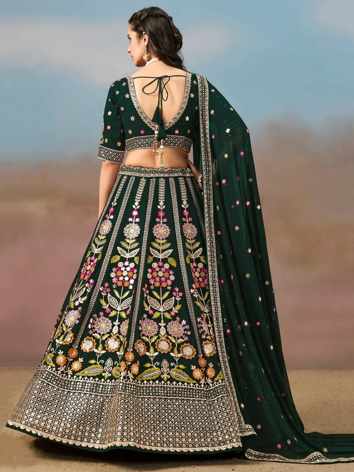 Emerald green designer lehenga choli with floral embroidery and back tie blouse, perfect for Indian weddings.