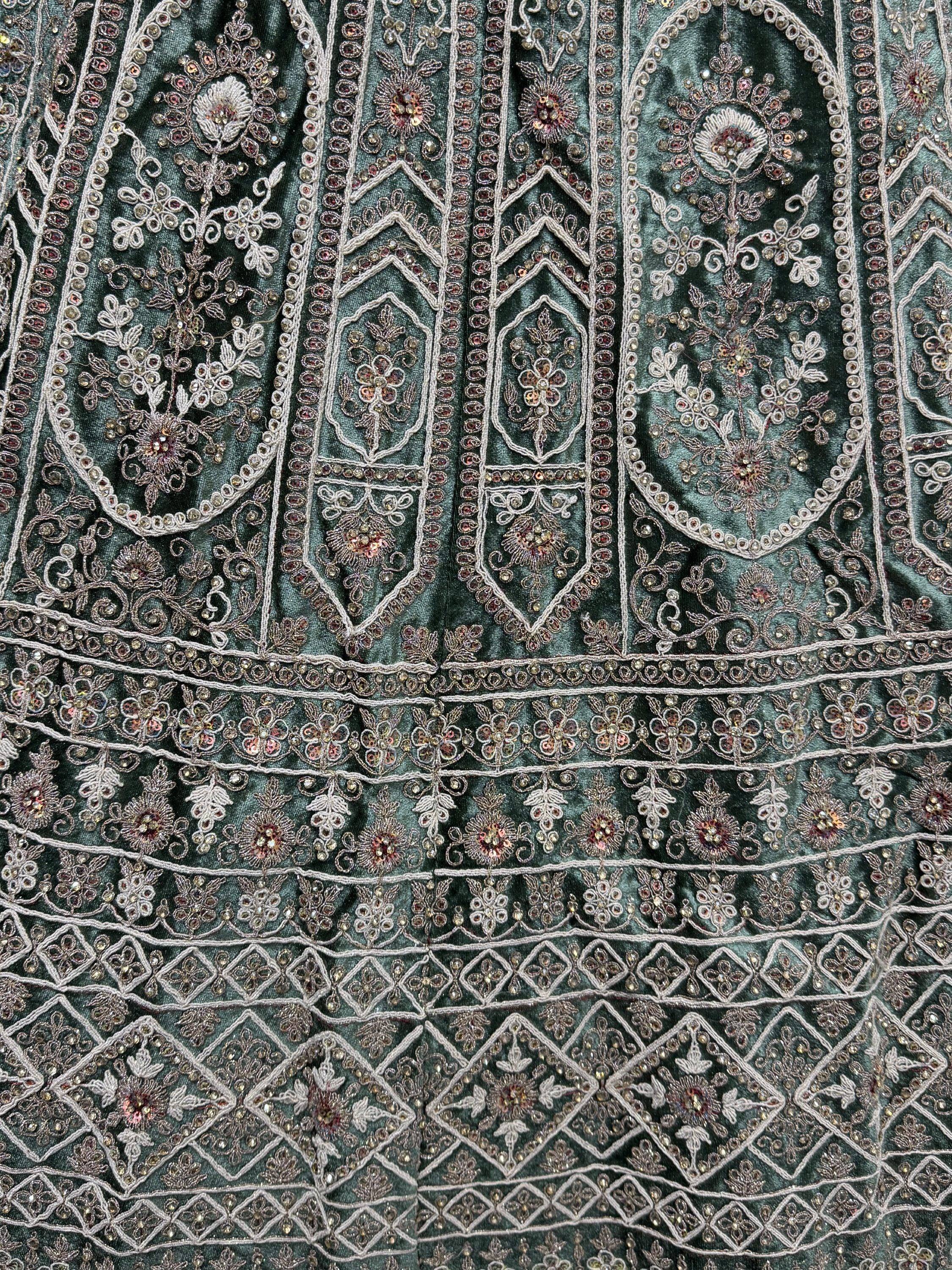 Teal velvet ethnic wear with intricate floral embroidery and sequin detailing, perfect for festive occasions.