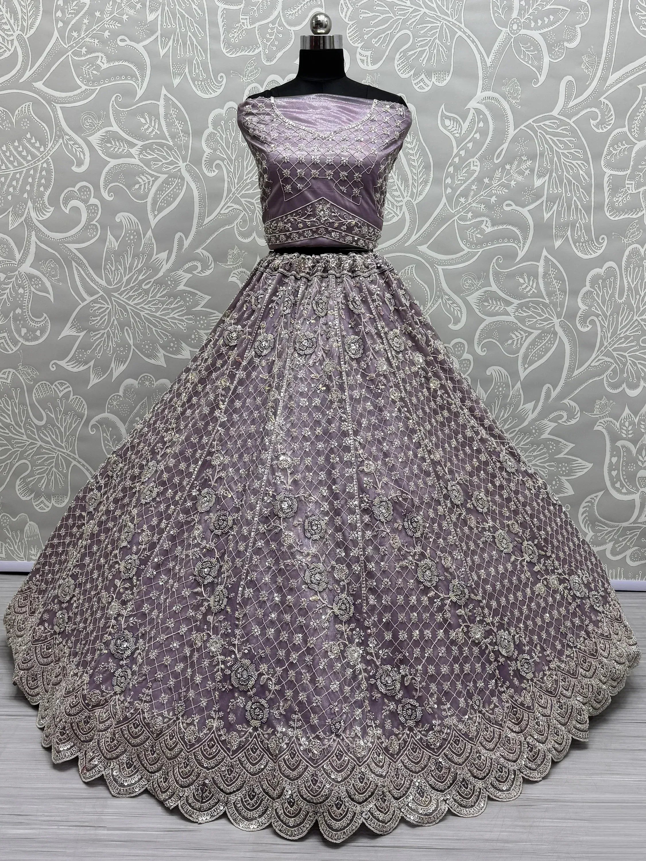 Lavender designer lehenga choli with heavy silver embroidery, perfect for Indian weddings and ethnic events.