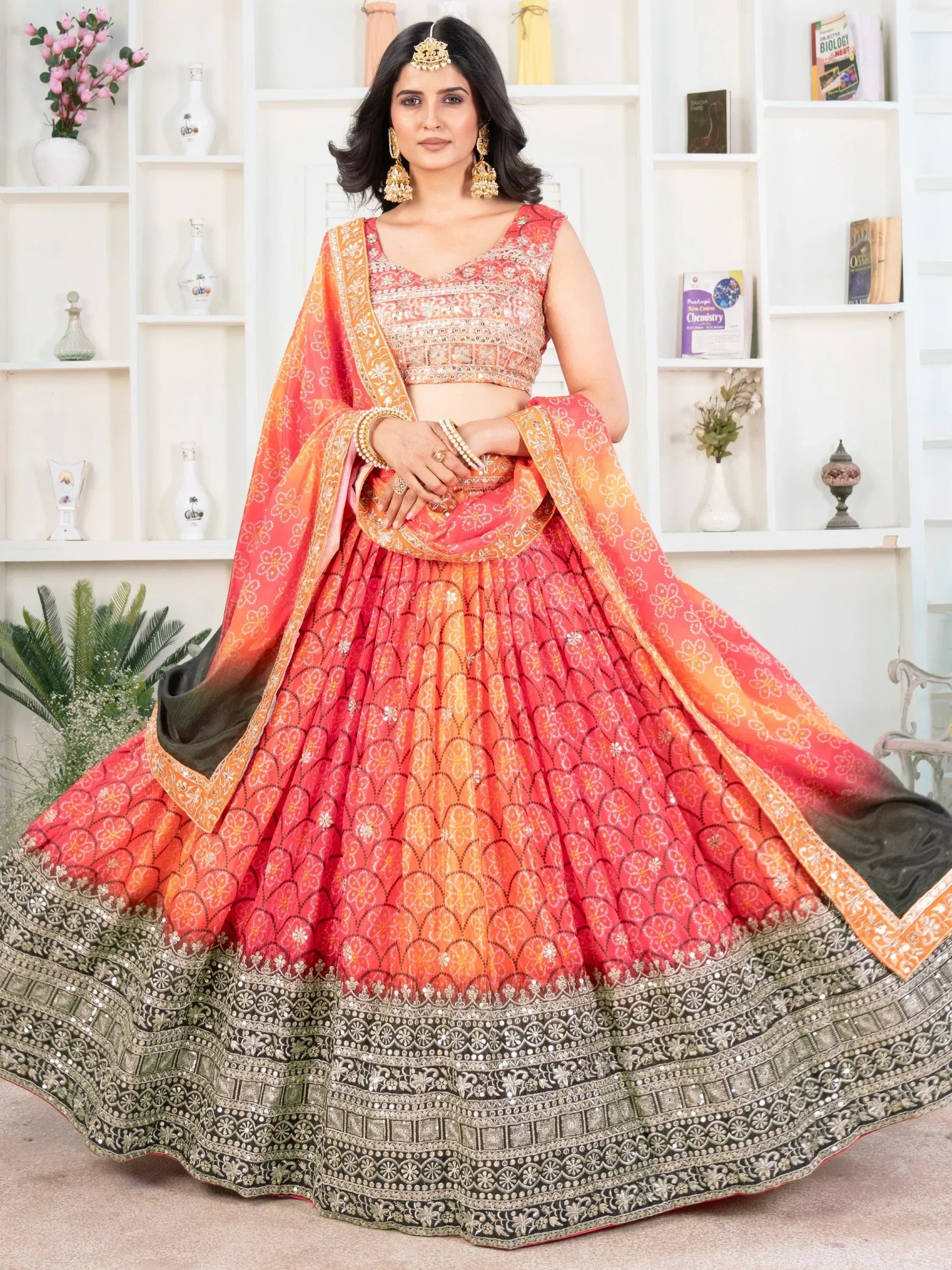 Orange pink ombre lehenga choli with floral print and gold embroidery, perfect for Indian weddings and festive occasions