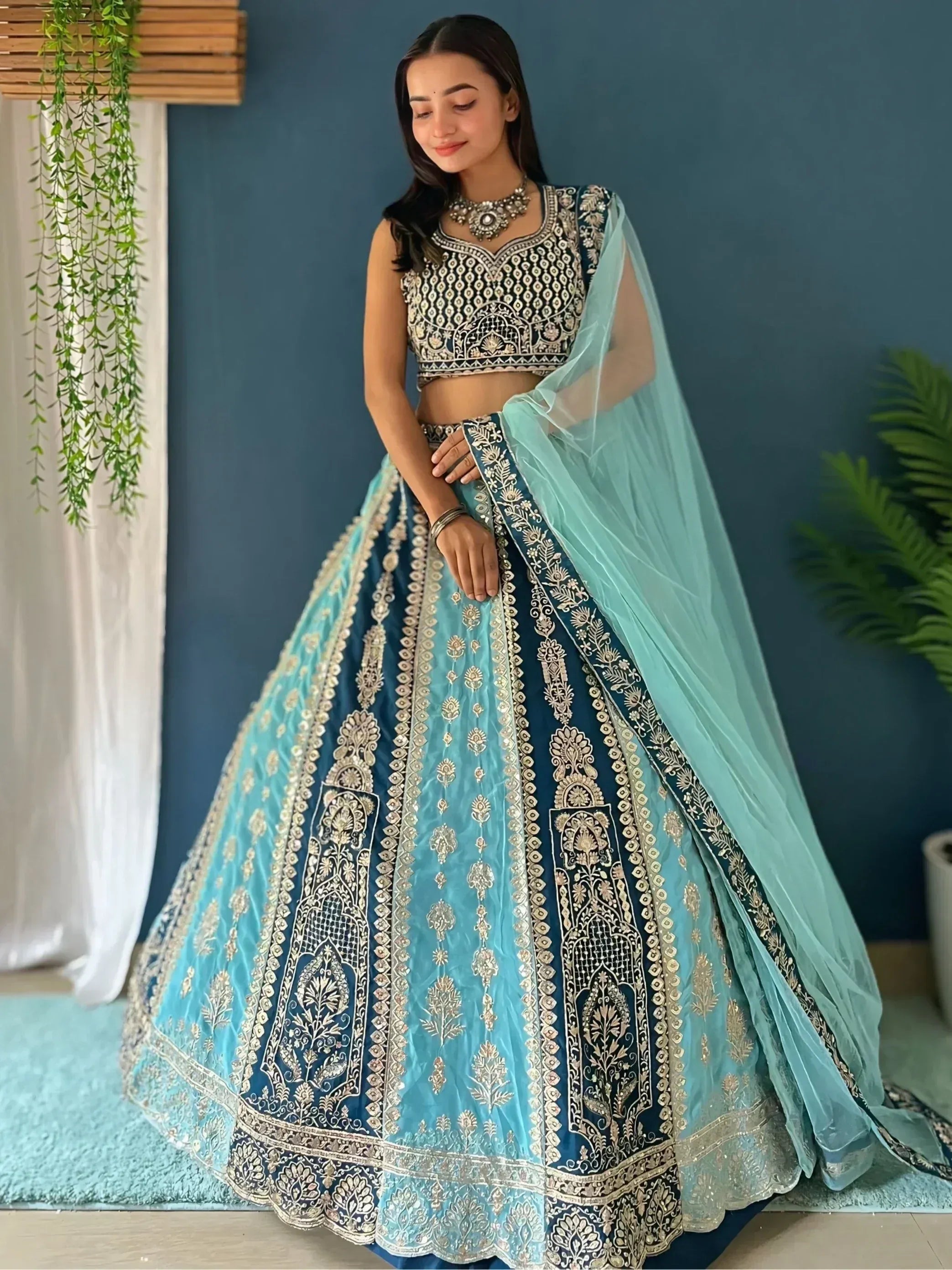 Blue and teal embroidered lehenga choli with gold detailing, perfect for Indian ethnic wear occasions.