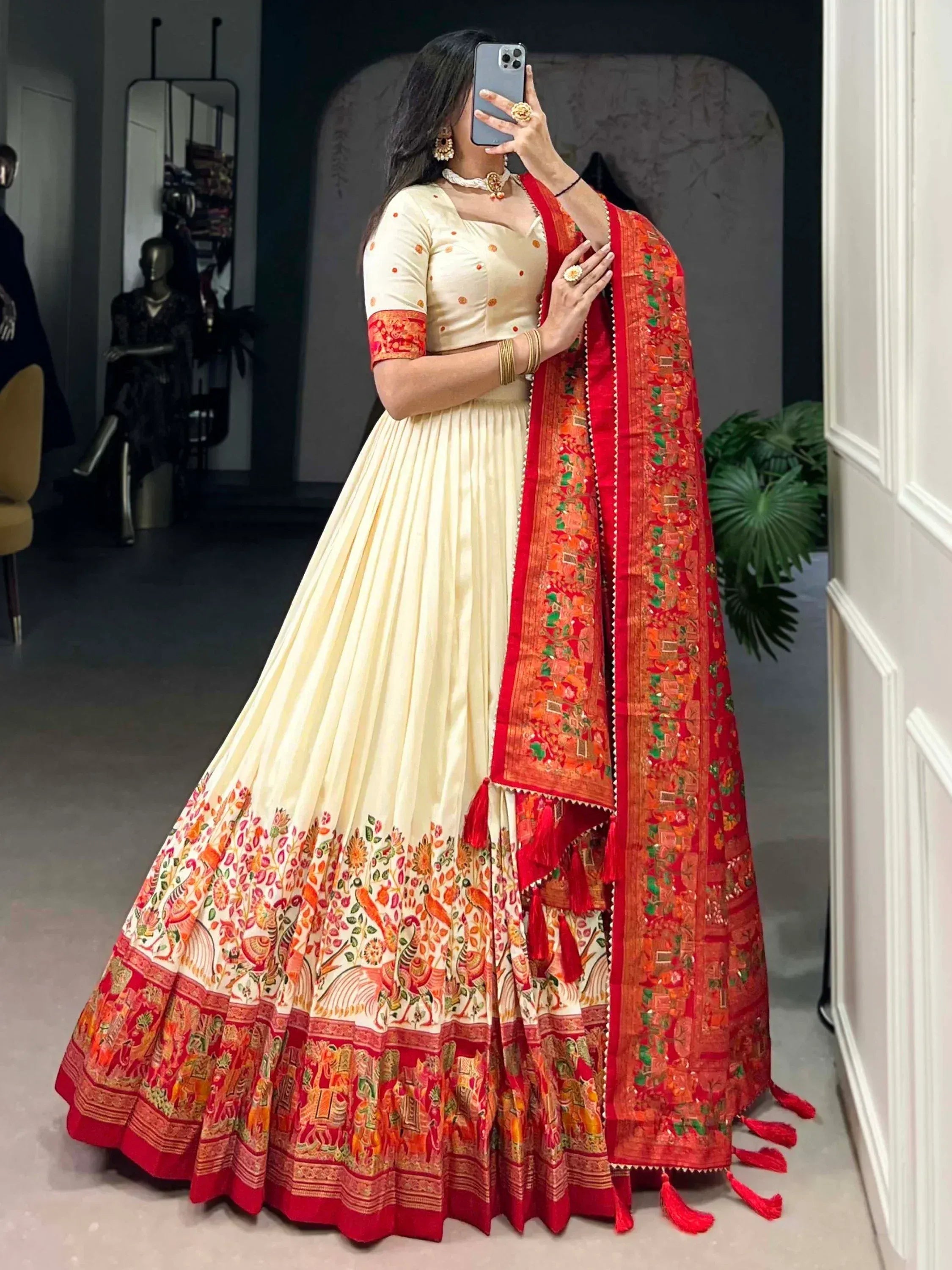 Cream and red printed lehenga choli with floral motifs and matching dupatta, perfect for Indian ethnic wear occasions