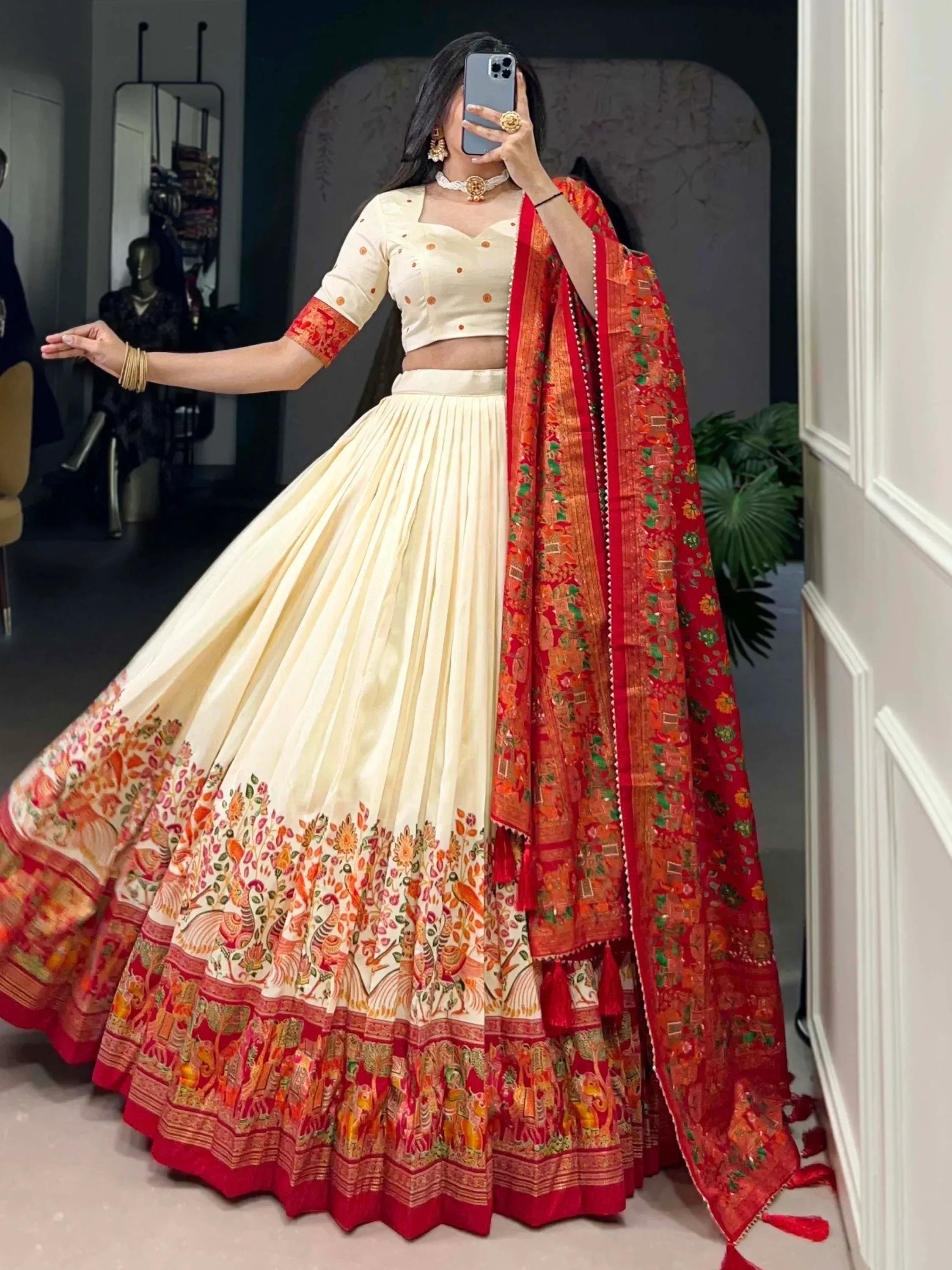 Cream and red embroidered lehenga choli with floral border, perfect for Indian weddings and festive occasions