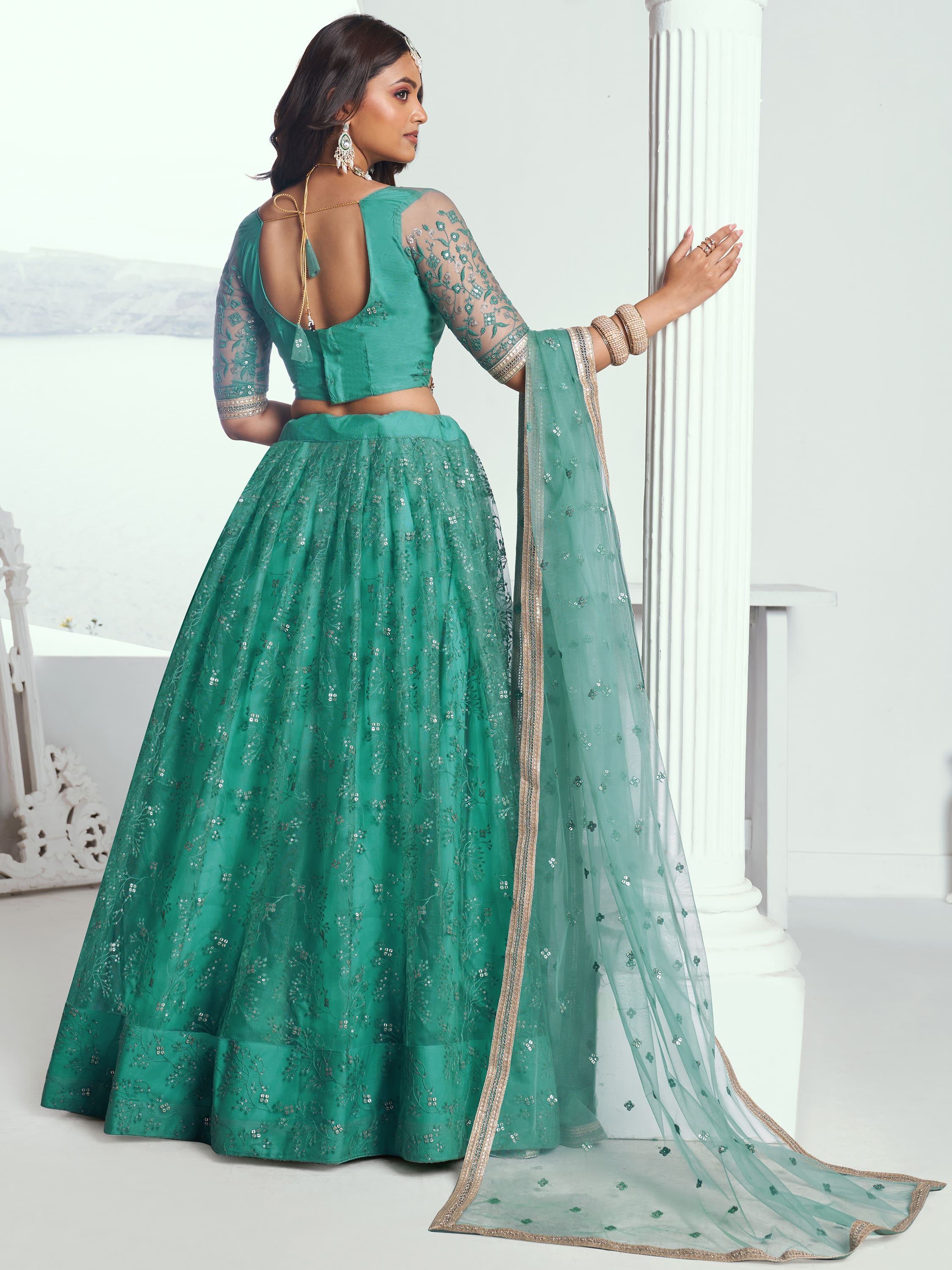 Emerald green designer lehenga choli with sheer sleeves, floral embroidery, and sequin detailing for Indian ethnic wear