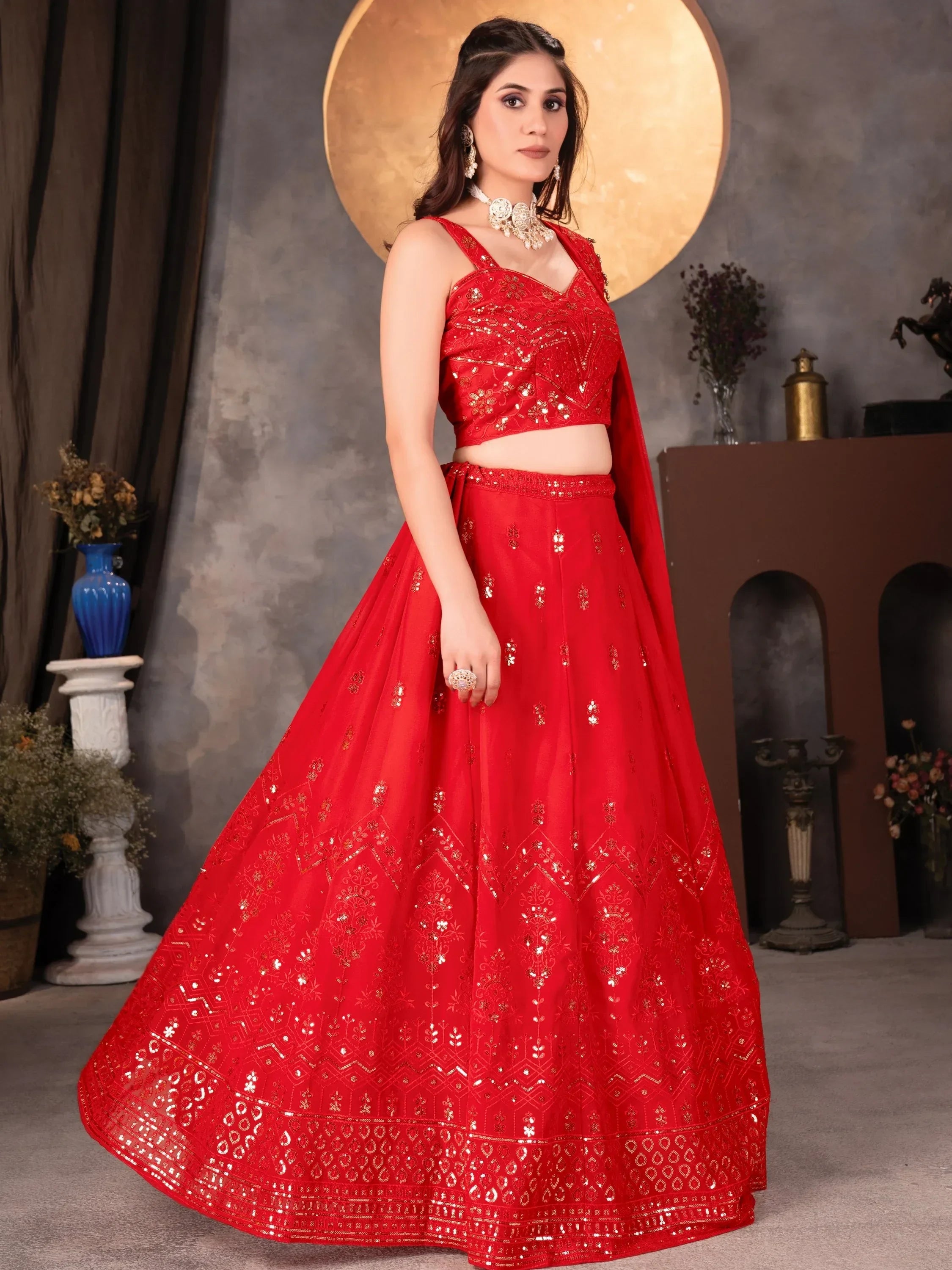 Red designer lehenga choli with gold embroidery and sequins, perfect for Indian weddings and festive occasions
