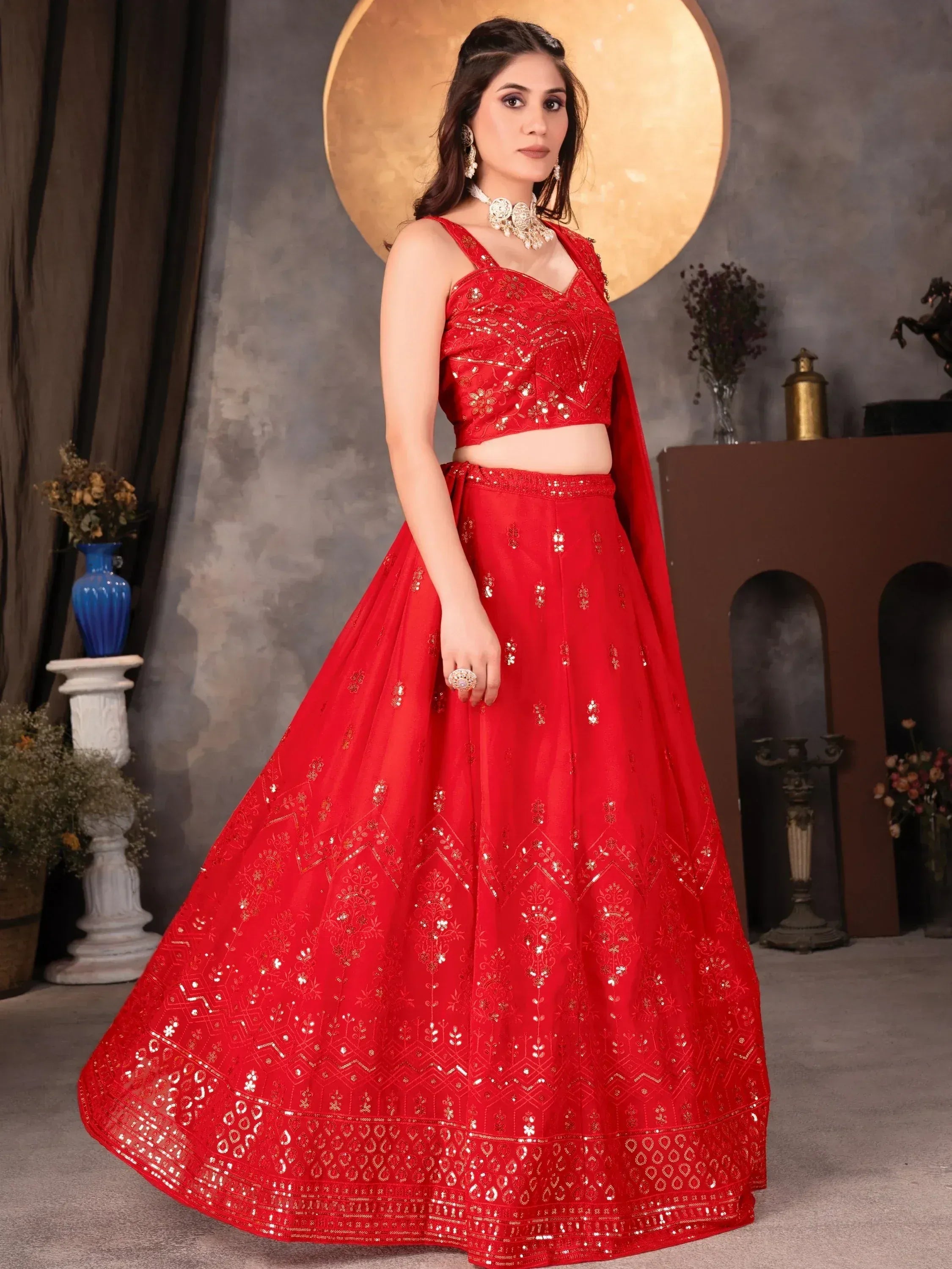 Red designer lehenga choli with gold embroidery and sequins, perfect for Indian weddings and festive occasions