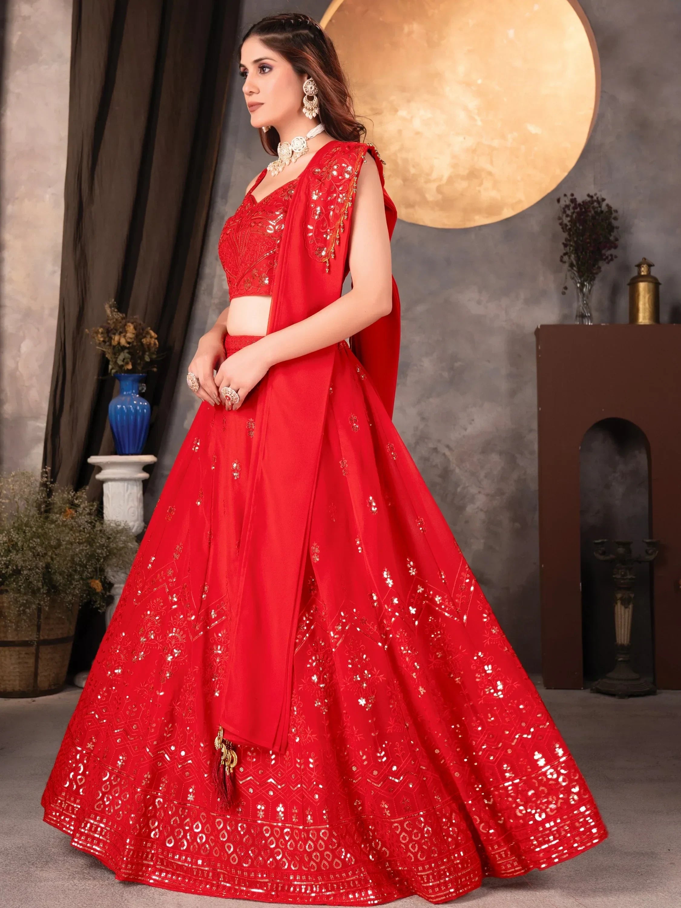 Red designer lehenga choli with gold embroidery and sequins, perfect for Indian weddings and festive occasions