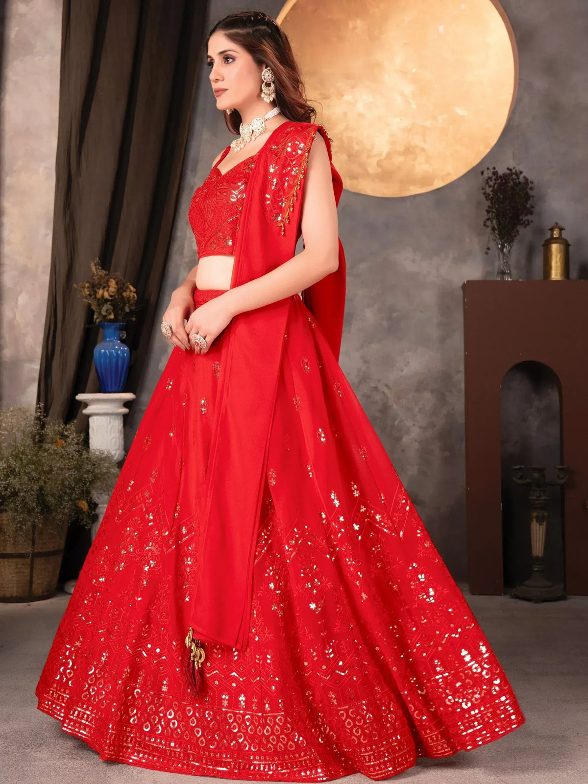 Red designer lehenga choli with gold embroidery and sequins, perfect for Indian weddings and festive occasions