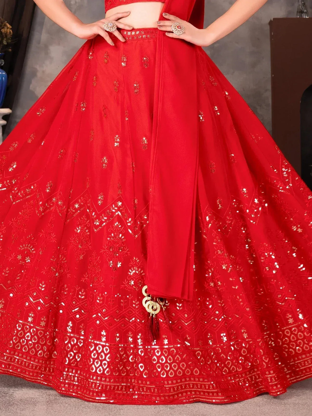 Red designer lehenga choli with gold embroidery and mirror work, perfect for Indian ethnic wear occasions