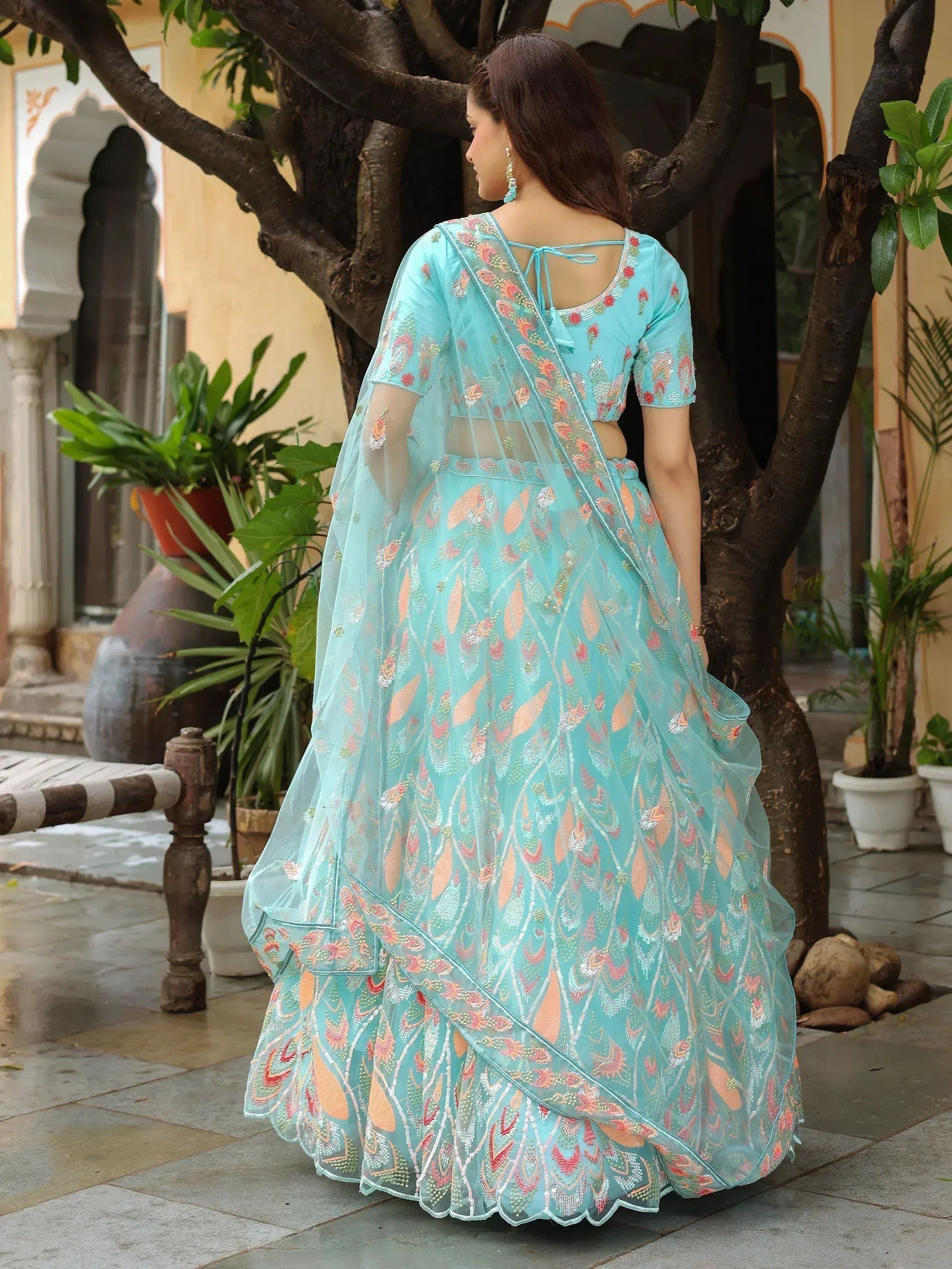 Turquoise embroidered lehenga choli with floral motifs, perfect for Indian ethnic wear occasions