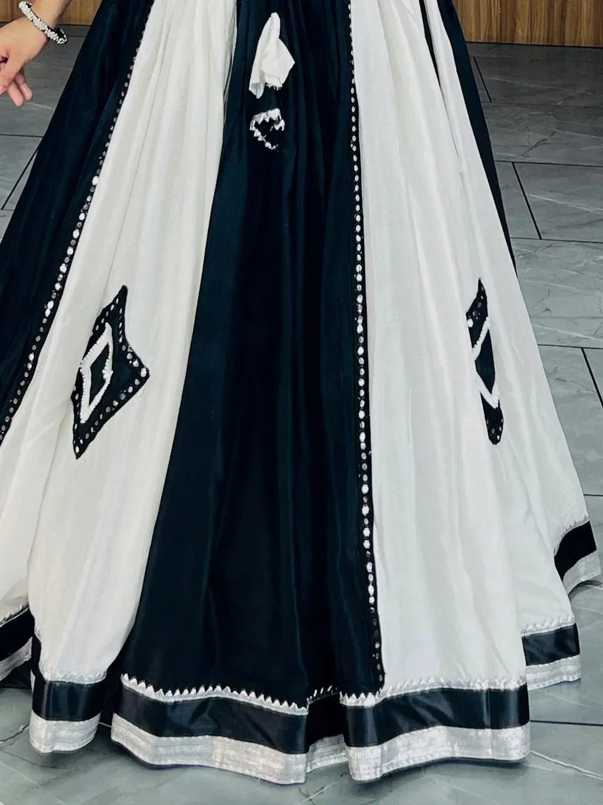 Black and white ethnic lehenga with geometric embroidery and sequin detailing for festive occasions