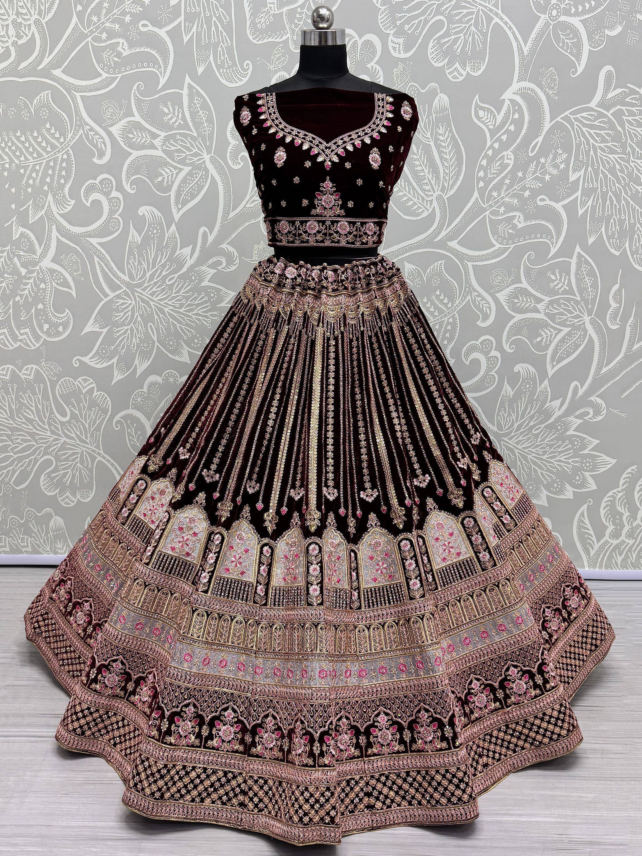 Elegant maroon velvet lehenga choli with gold and pink embroidery, perfect for Indian ethnic wear.
