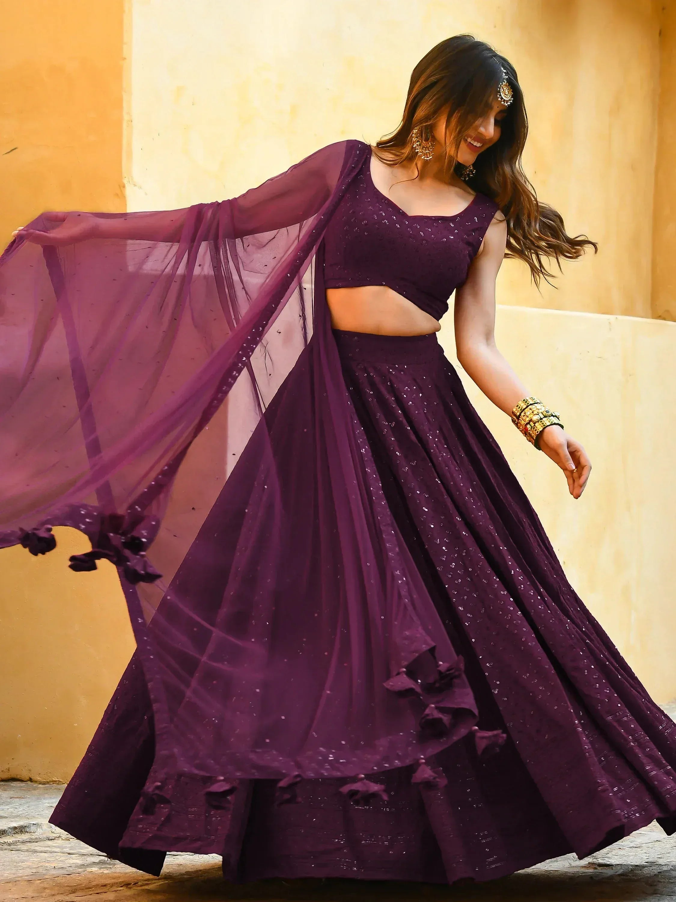 Elegant purple lehenga choli with sequins and sheer dupatta, perfect for Indian ethnic occasions.