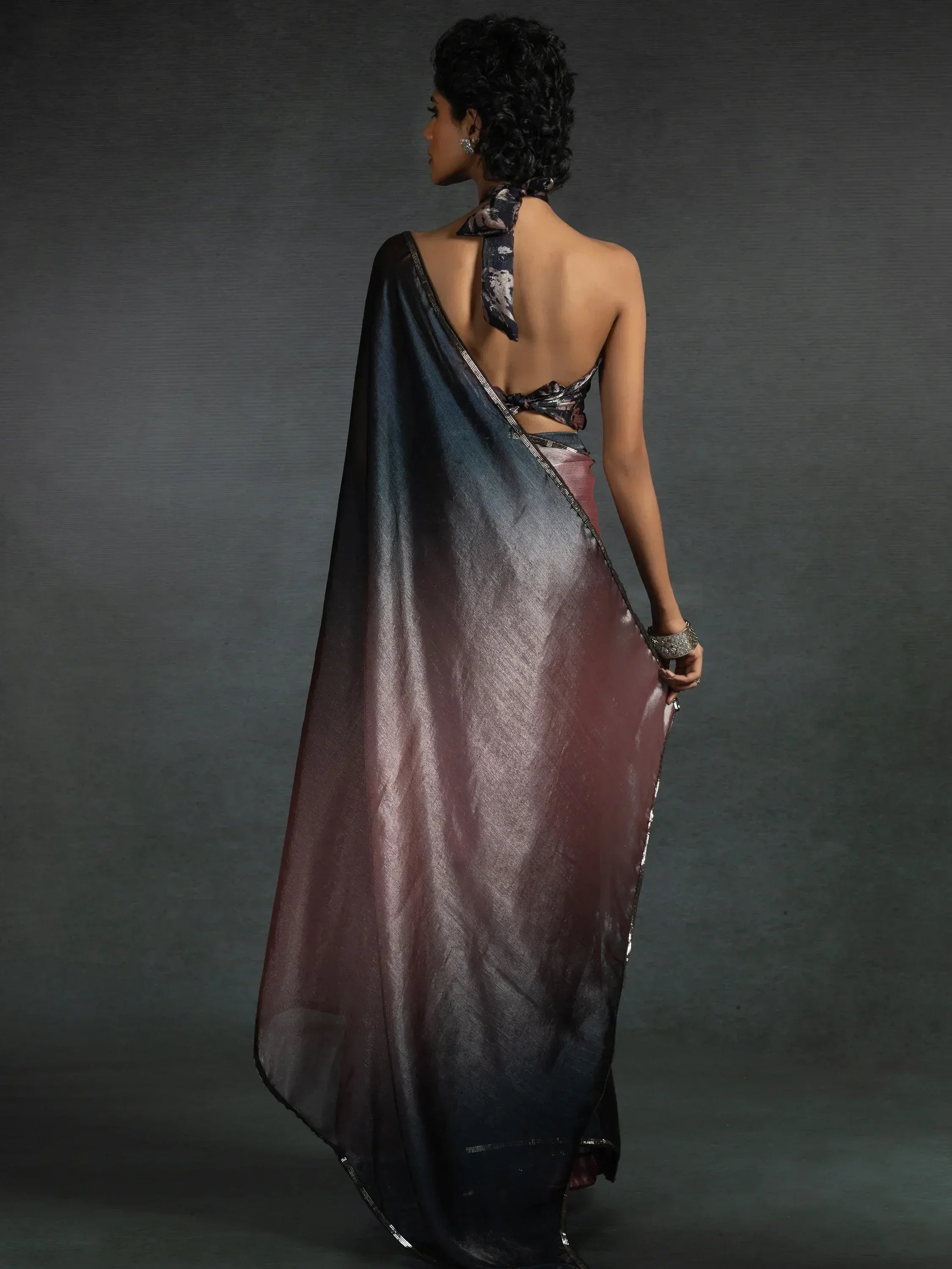 Stylish backless saree with ombre effect and floral blouse, perfect for ethnic occasions.
