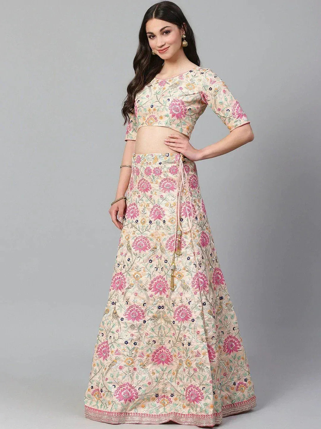 Floral embroidered lehenga choli with pink and cream motifs, perfect for Indian ethnic occasions