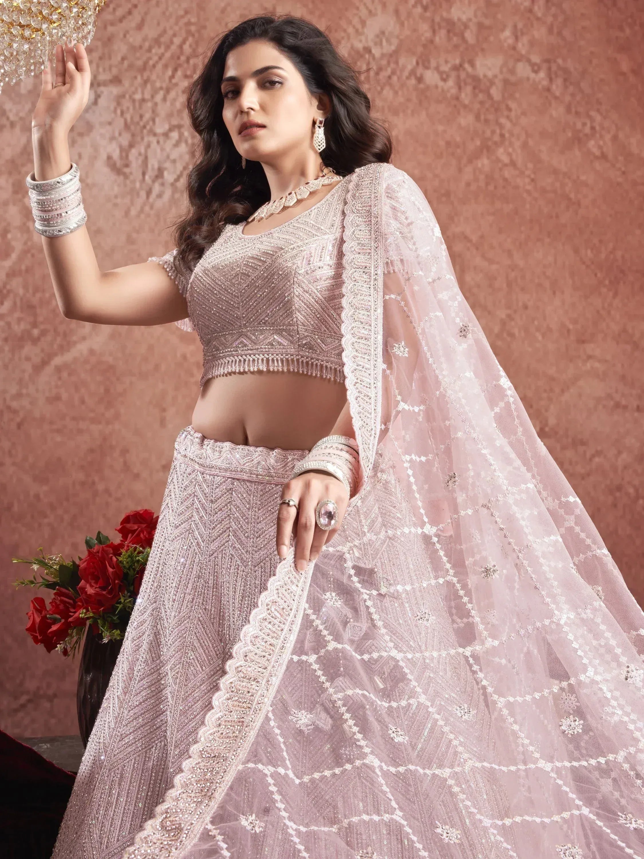 Elegant pink designer lehenga choli with intricate embroidery and sheer dupatta for Indian ethnic wear