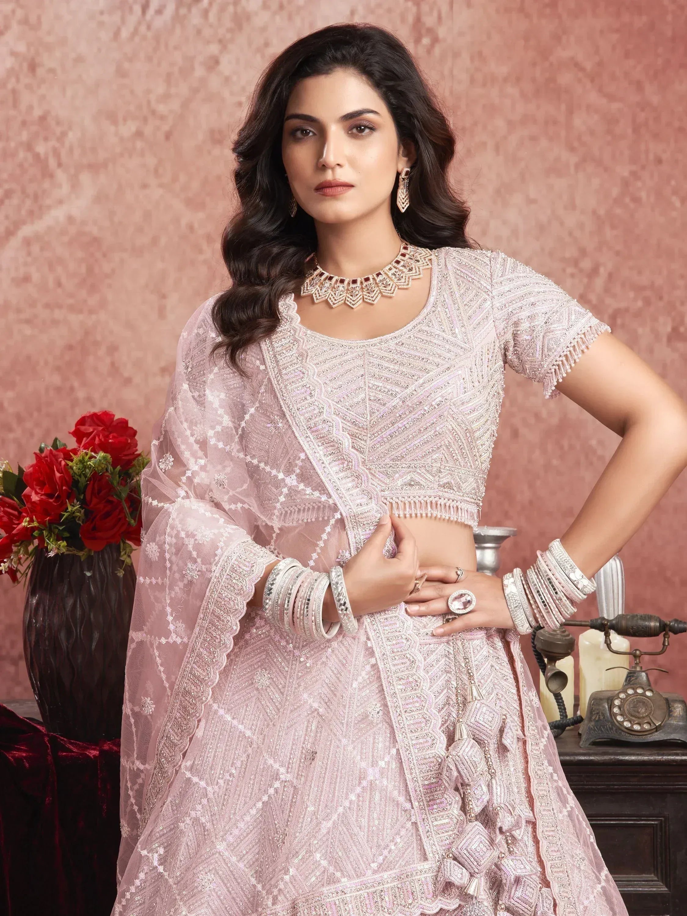 Elegant pink embroidered lehenga choli with matching dupatta, perfect for Indian weddings and festive occasions.