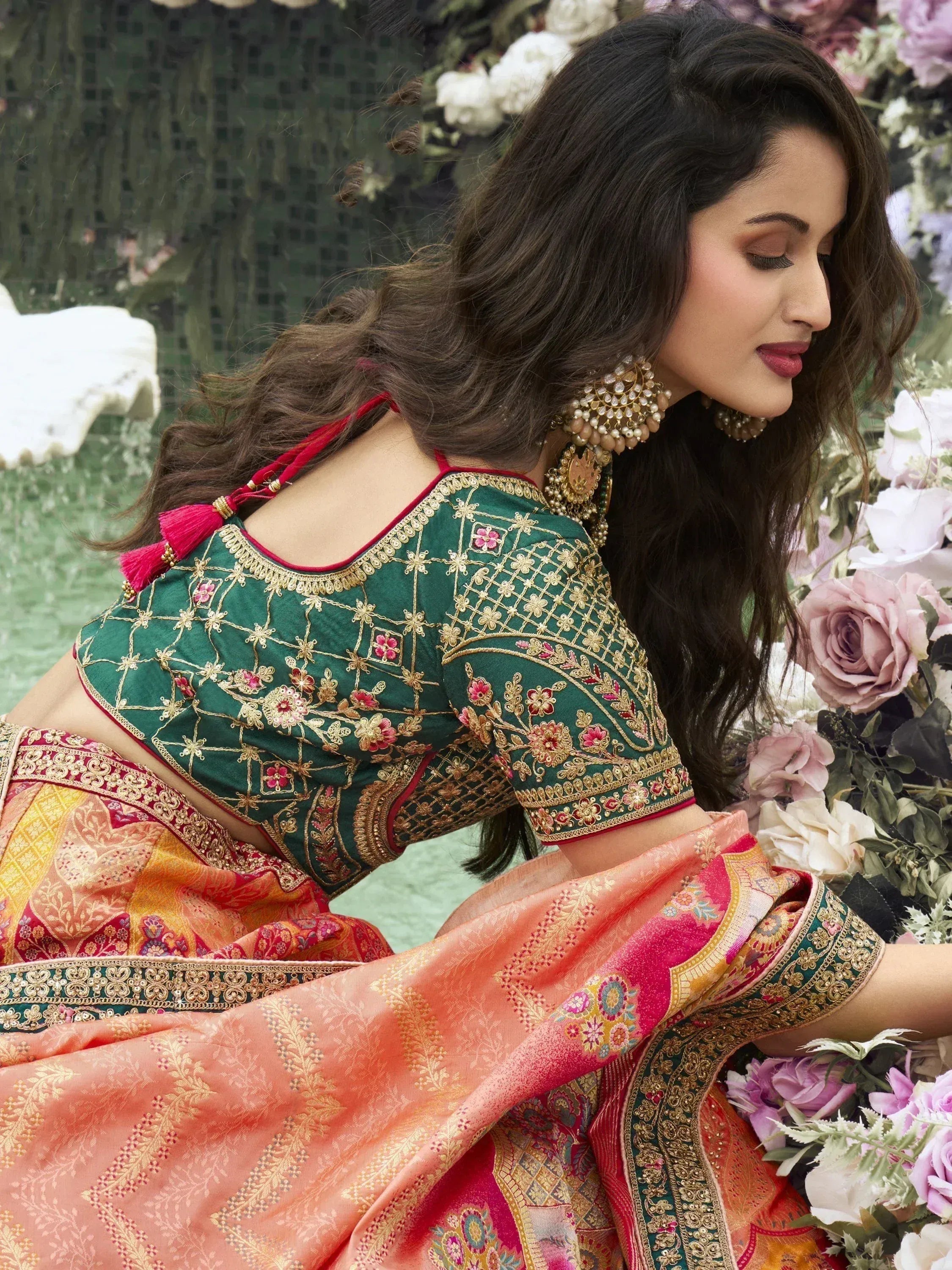 Woman in green embroidered lehenga choli with floral details, perfect for Indian ethnic wear occasions.