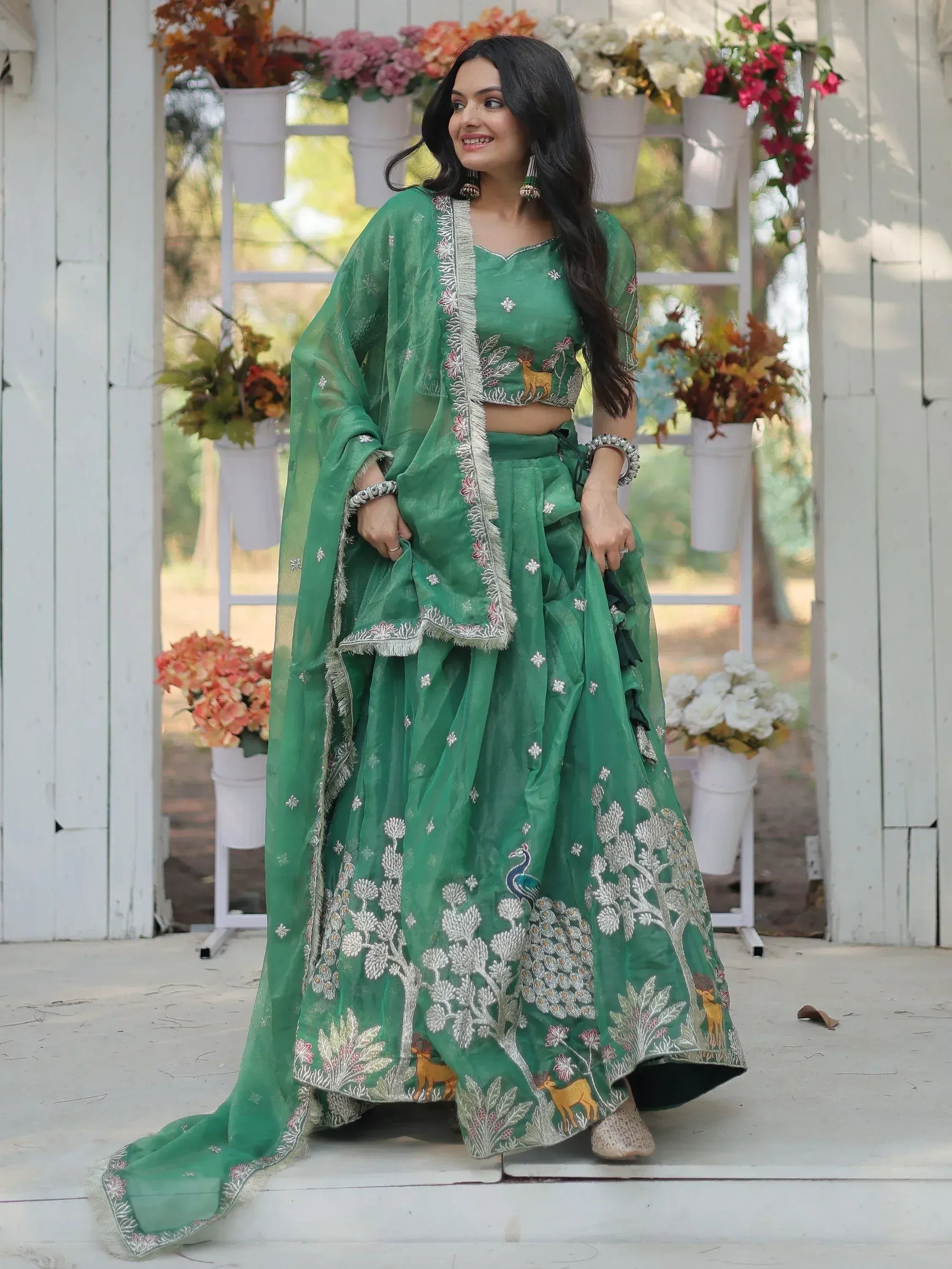 Emerald green embroidered lehenga choli with peacock and deer motifs, perfect for Indian ethnic occasions